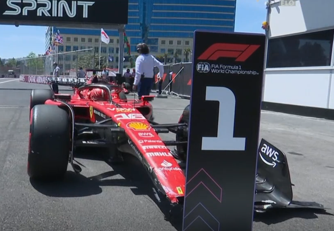 Charles Leclerc standing in the position for the pole car with a broken front wing