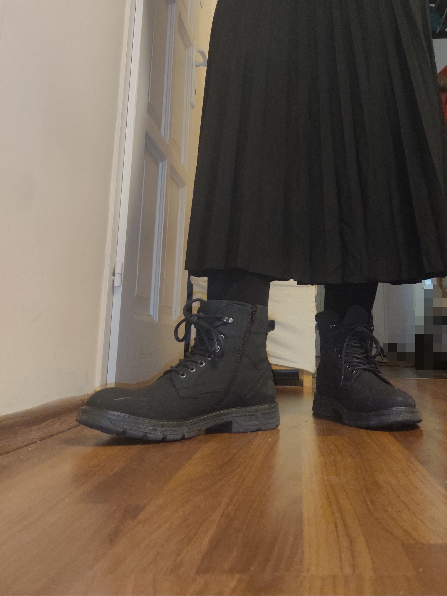 frontal pic of duc's lower body. they have a pair of black boots and black socks on, and a somewhat wavy skirt that almost reaches their boots