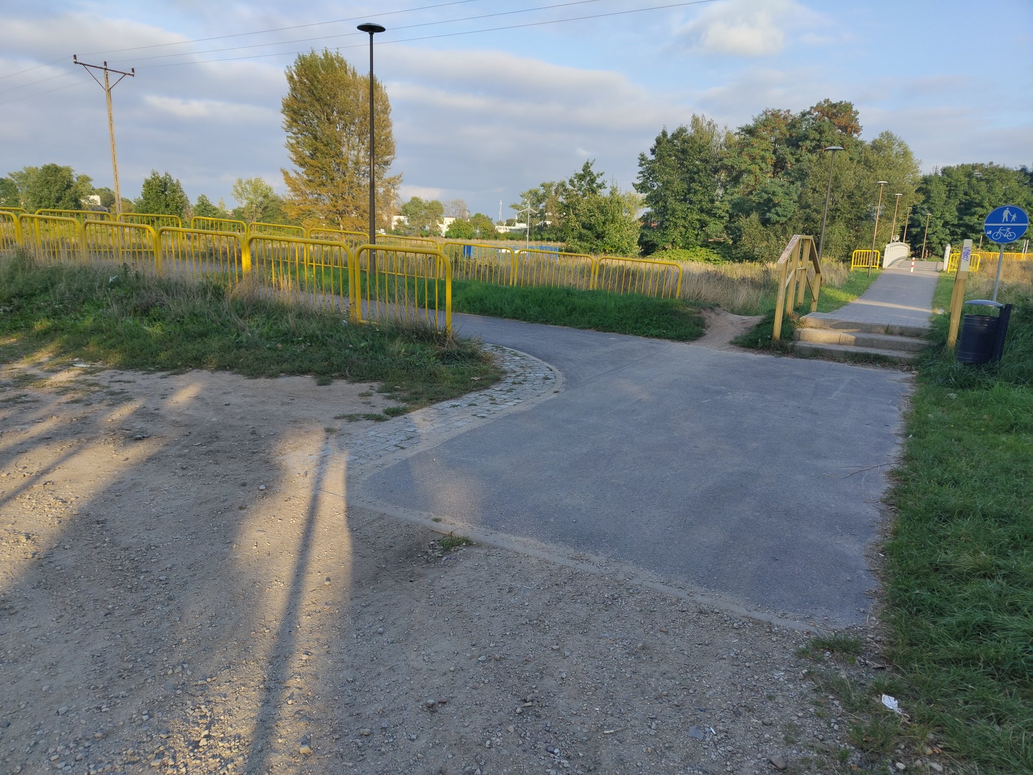 a long ass ramp for a ~1m bulge thing, with weird stairs for walking people, and a desire path made by bike next to stairs