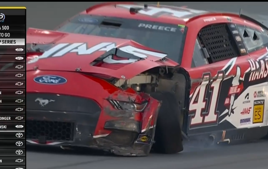 front left of a car heavily damaged with the wheel not looking straight