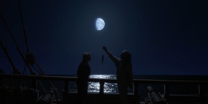 dark shot on a ship with the moon and the see (which is reflecting it) in the background, we see Stede and Ed opposite of each other, Ed is holding a fish in the middle