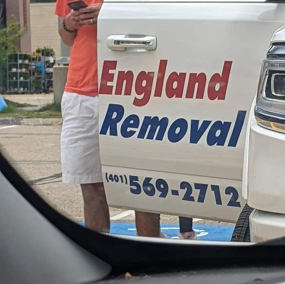 opened car door with "England Removal" written on it