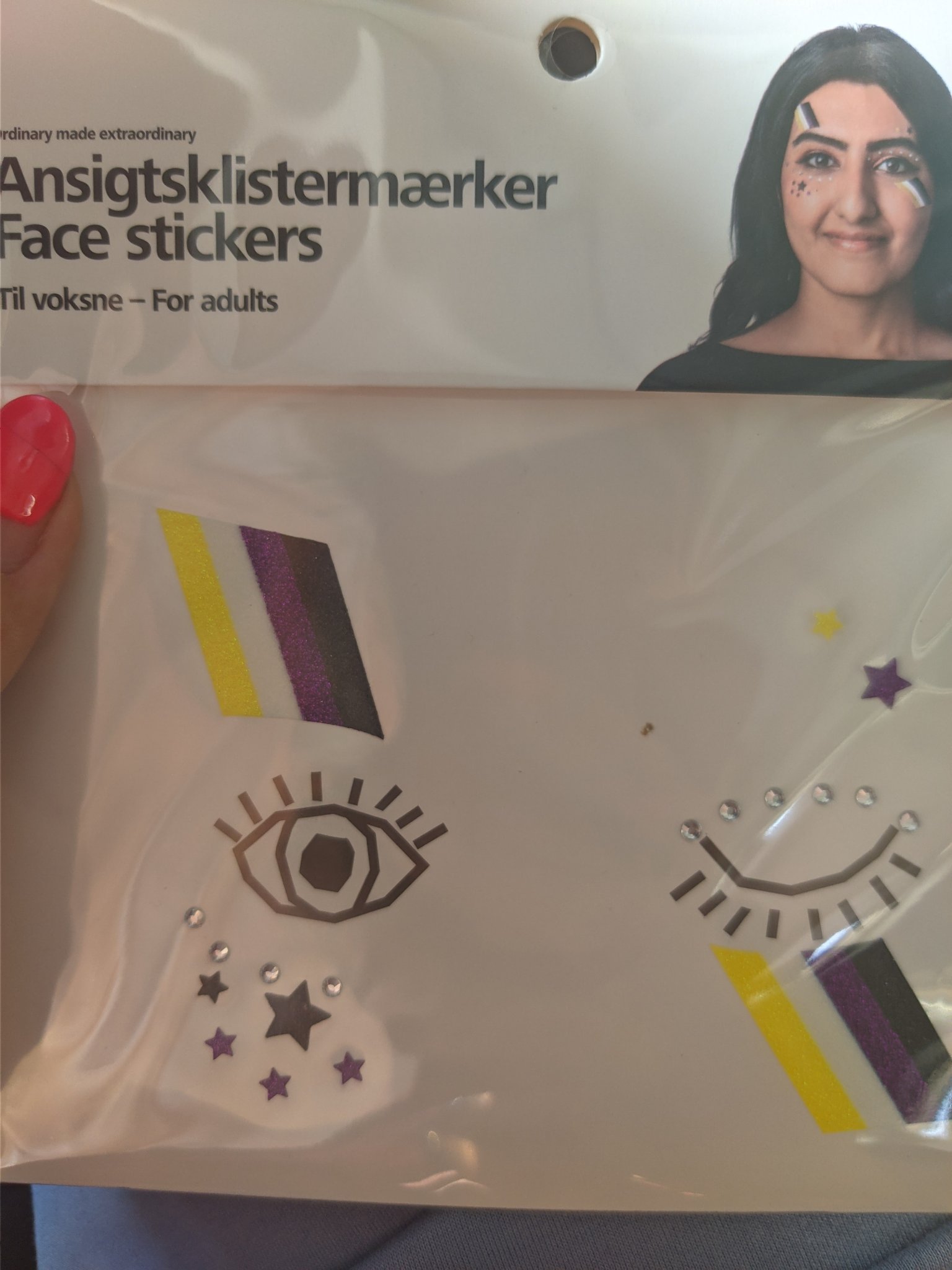 a small package with 2 stickers that have the non-binary flag on it, there are also some stars with the same colors