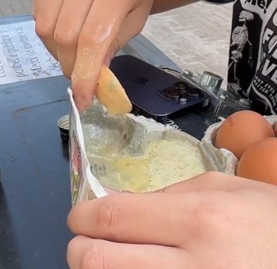 a box of eggs, the lid is being actively turned into so called "mayonnaise", aka a mixture of eggs and oil