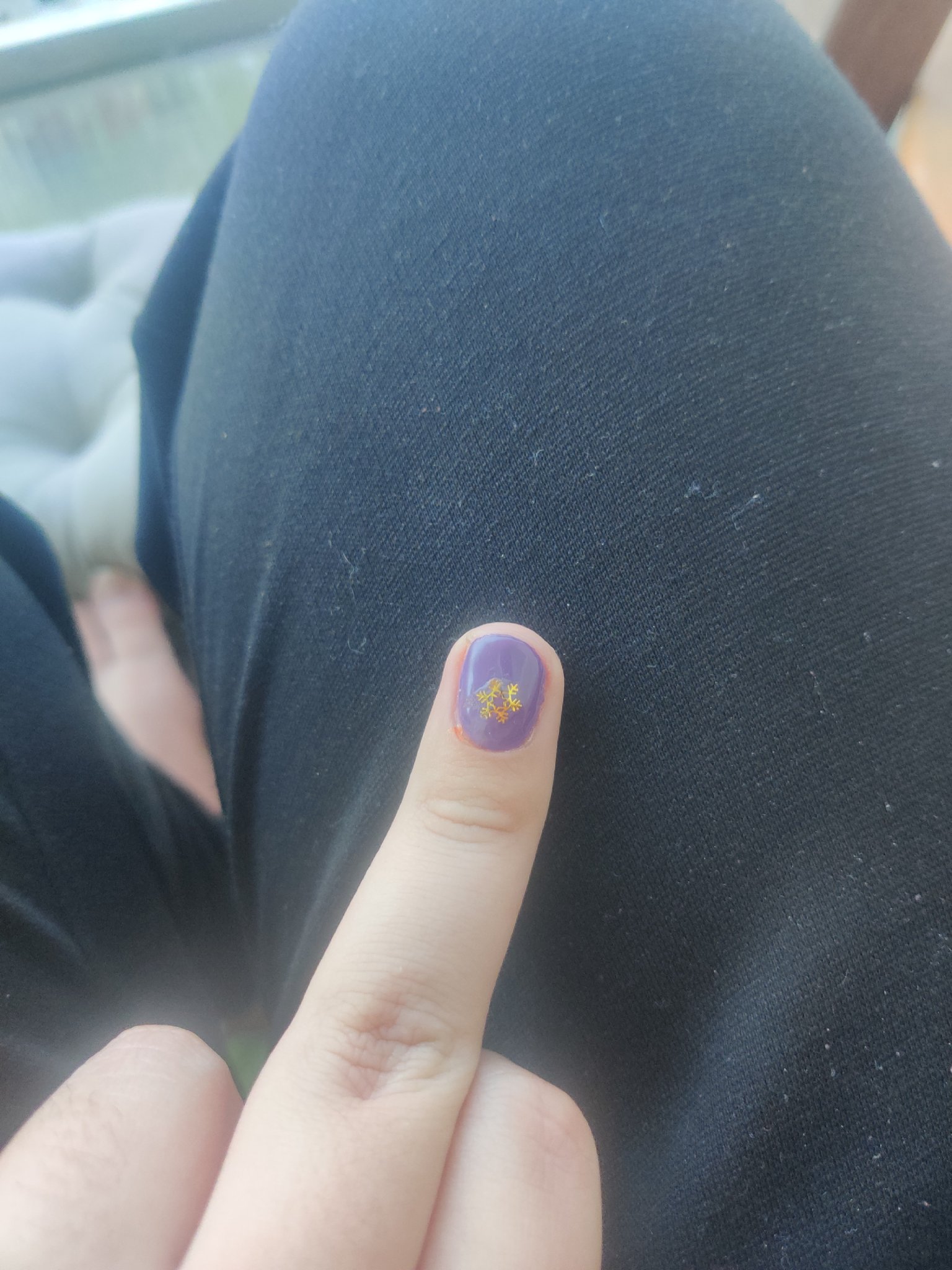 duc showing you their middle finger. ir's purple and has a snowflake on it