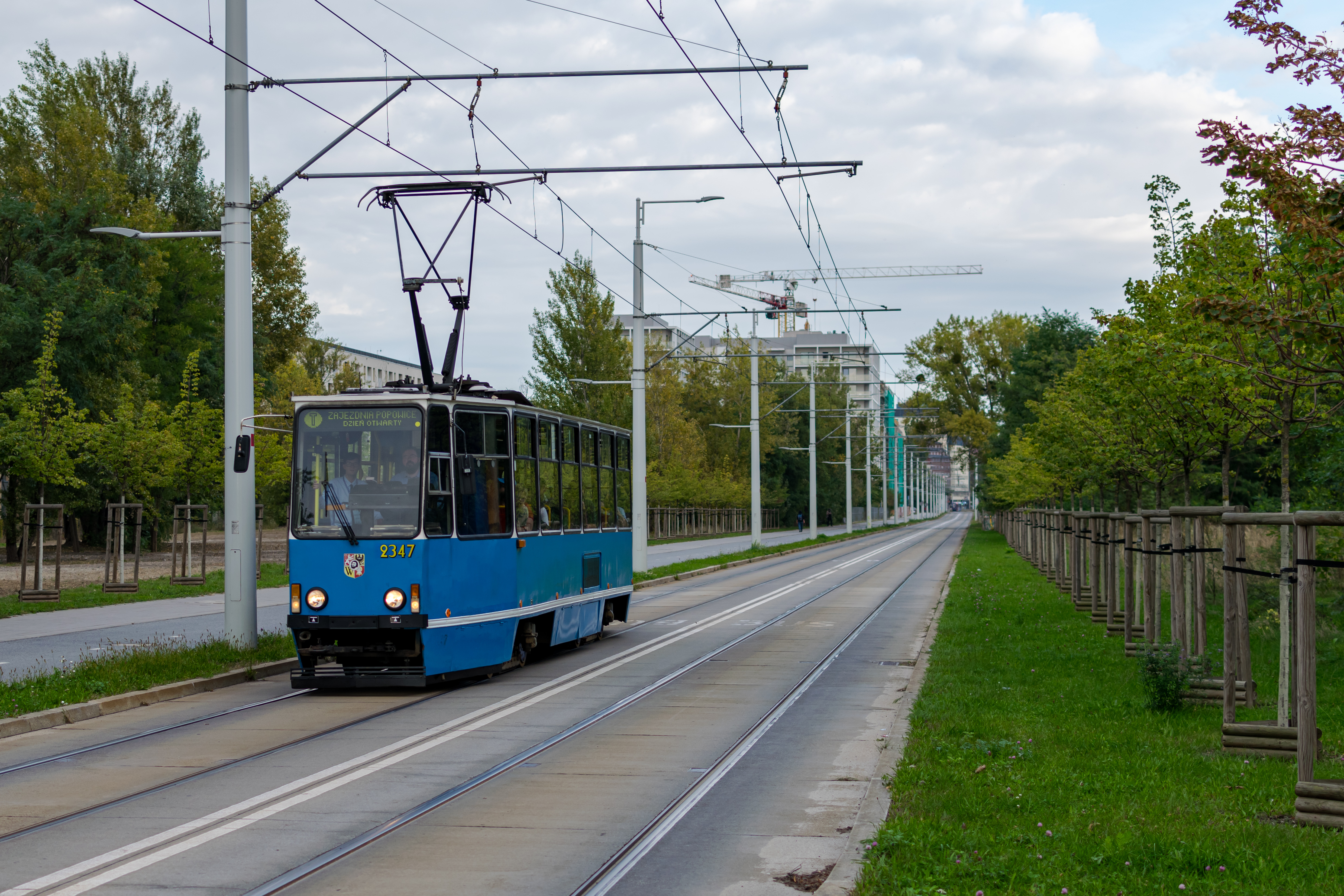 White-blue Konstal 105Na tram arriving at a stop