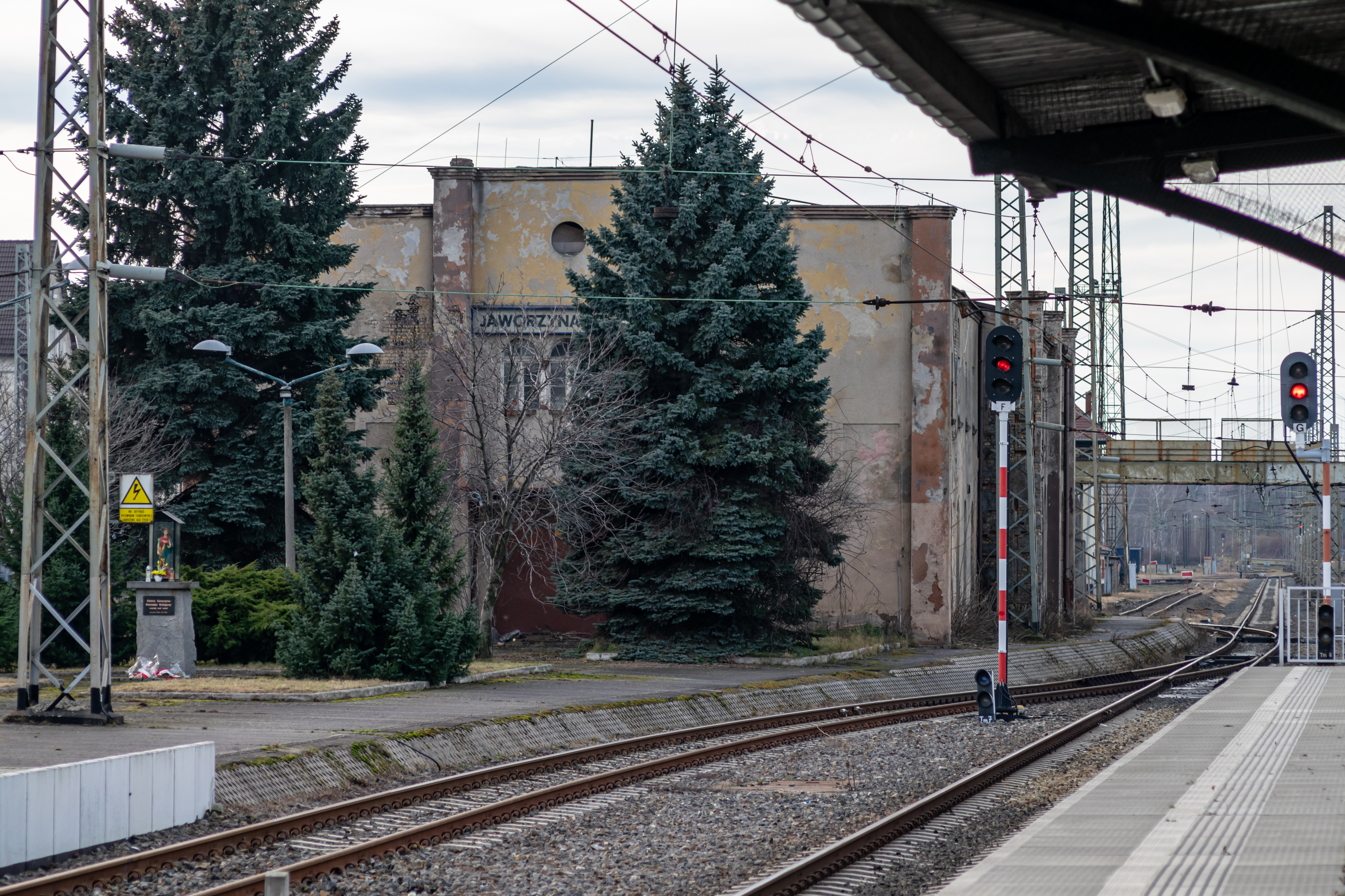 old station building behind a bunch of trees