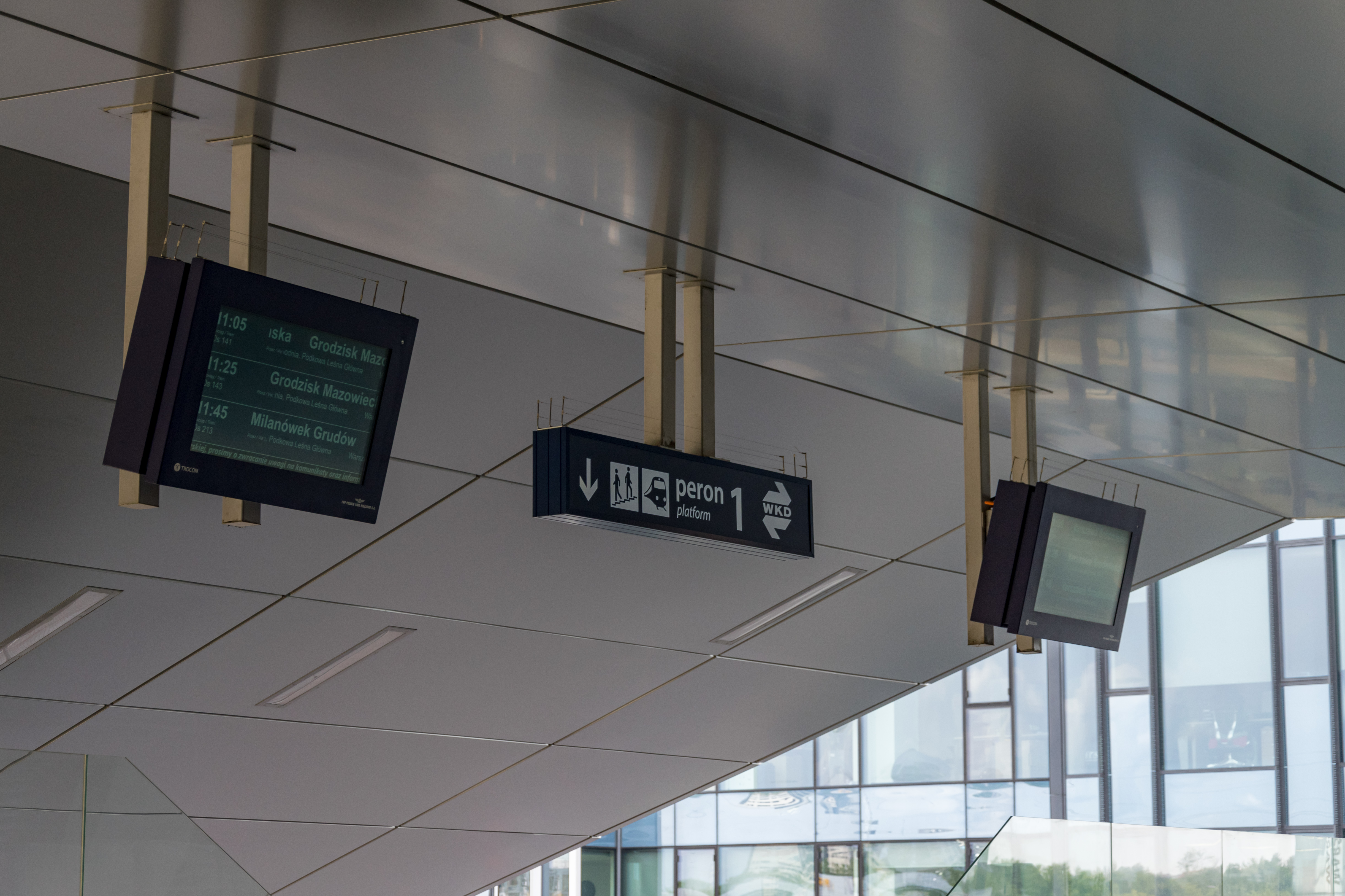 two departure displays and a sign directing to wkd platform