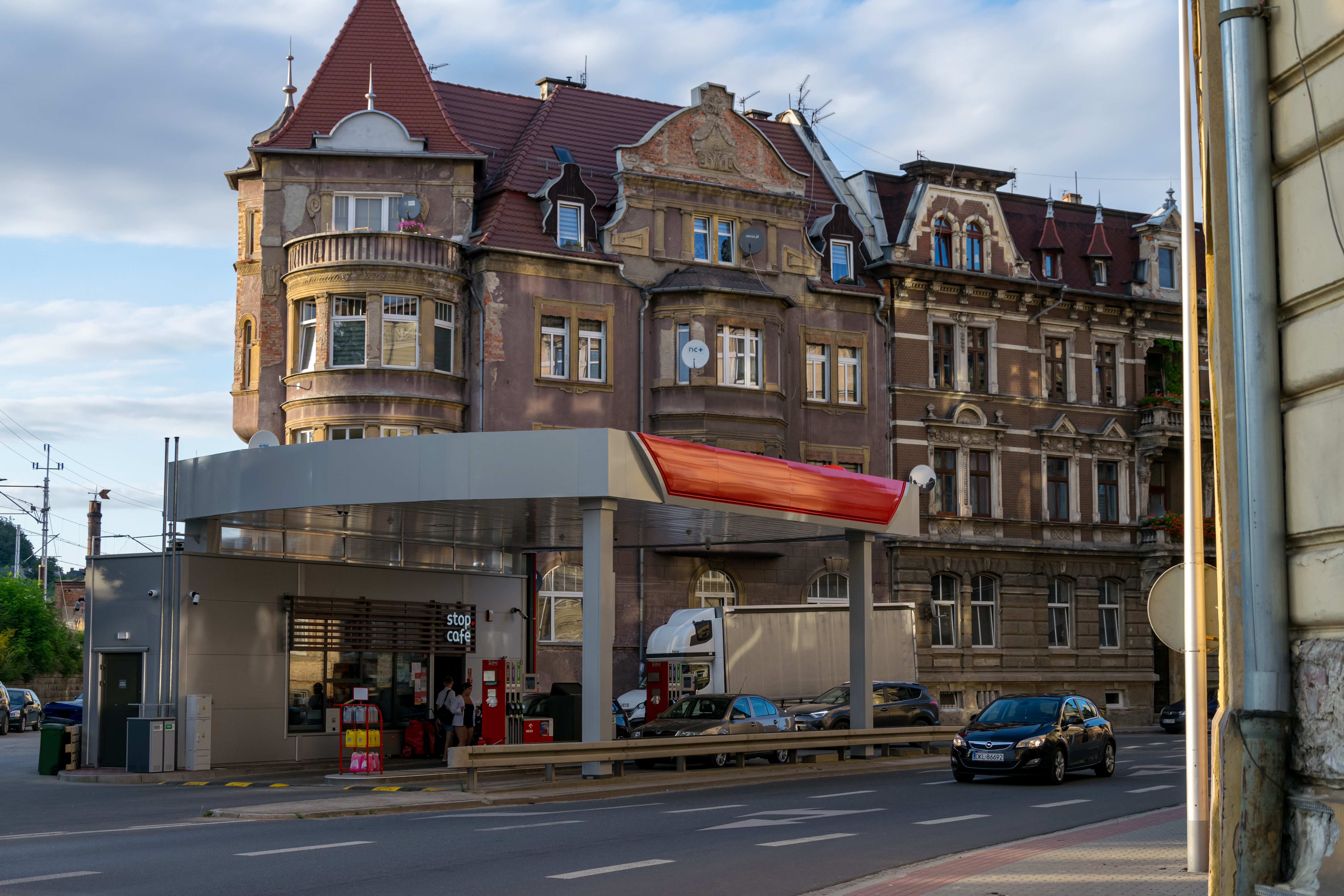 small urban petrol station with old building in the background