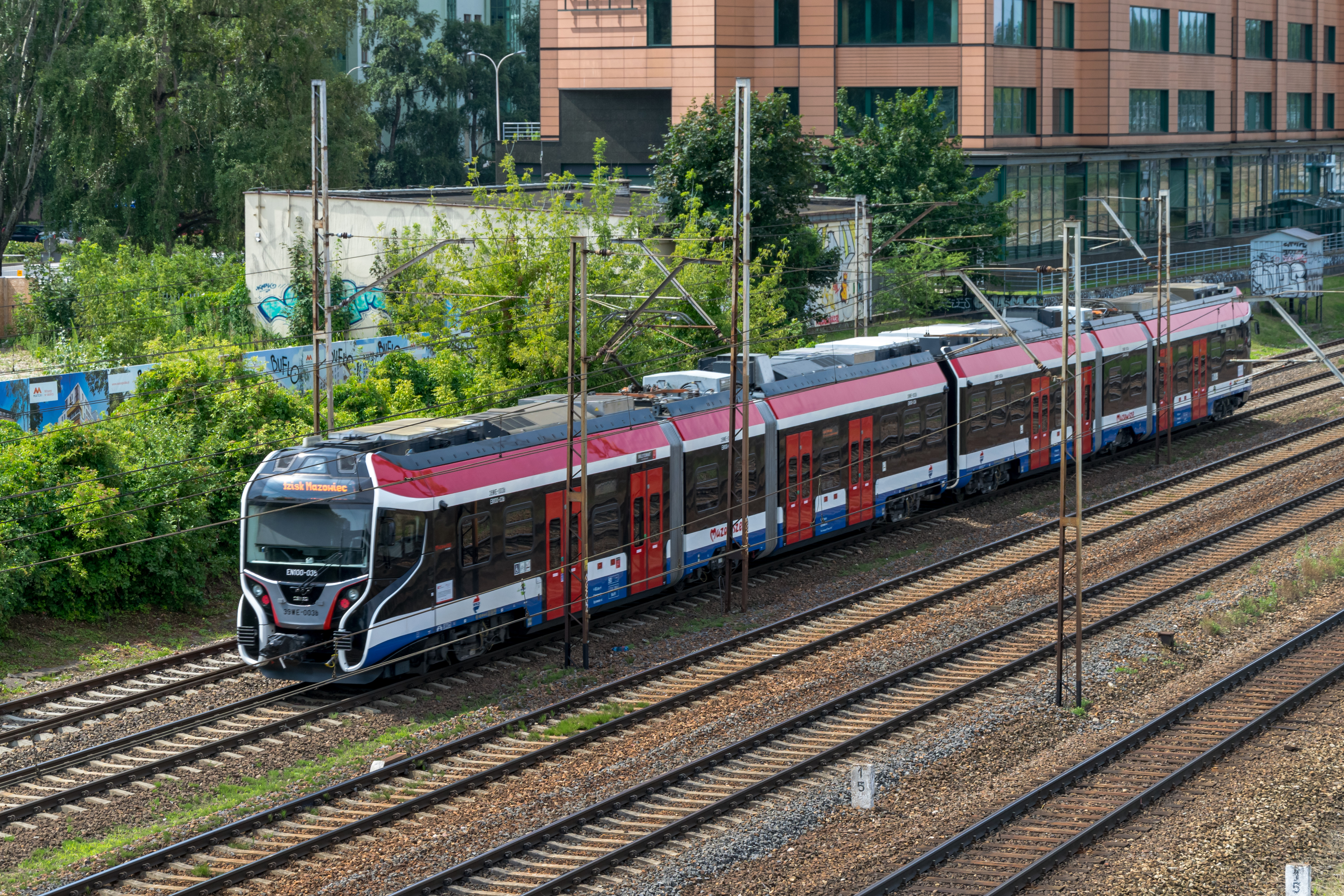 blue-white-black train with tram-like floor height