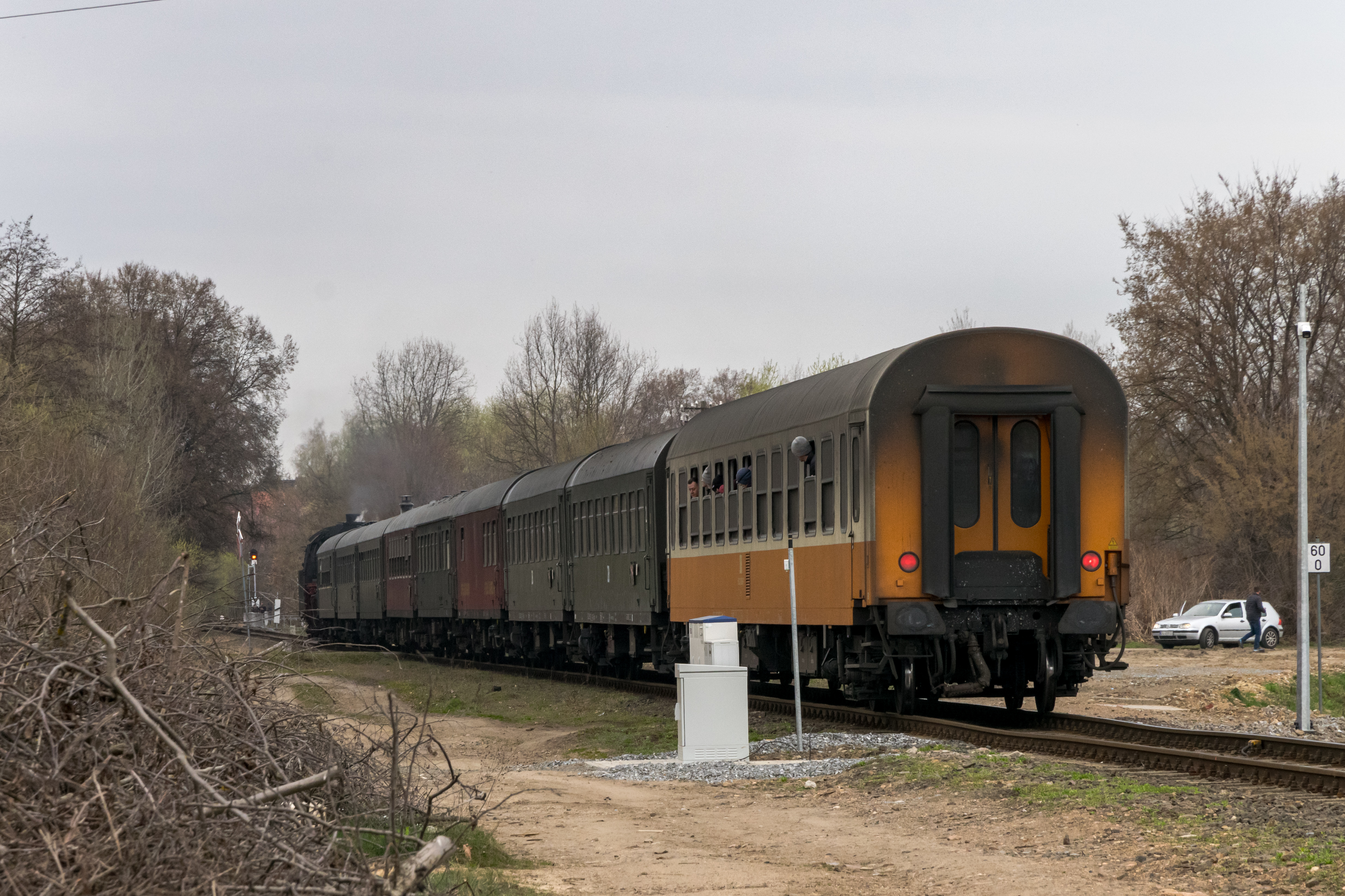 Rest of the train shown, 3 more brown passenger coaches, a red restaurant coach and a yellow-white passenger coach