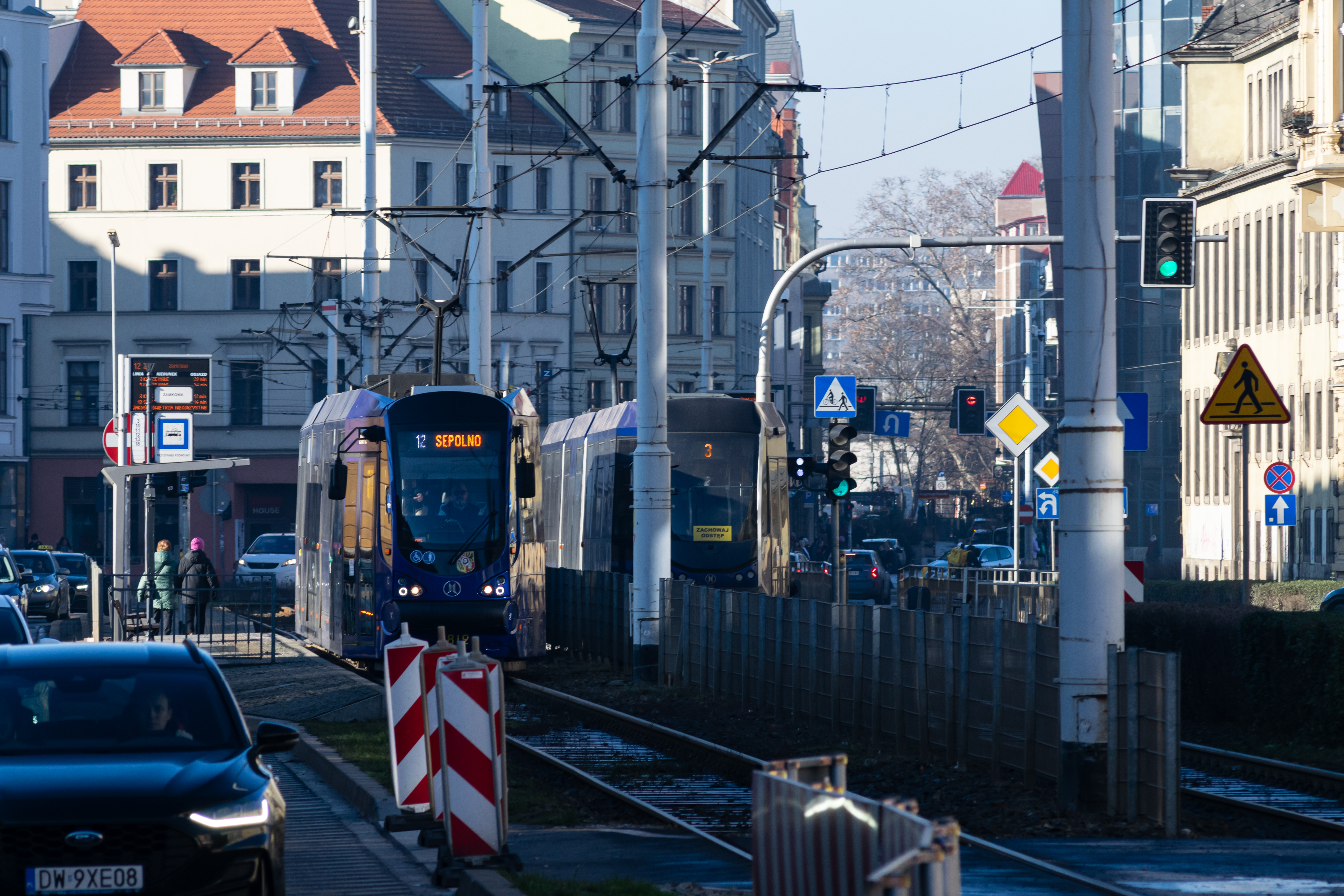 two dark-blue Moderus Betas at a tram stop