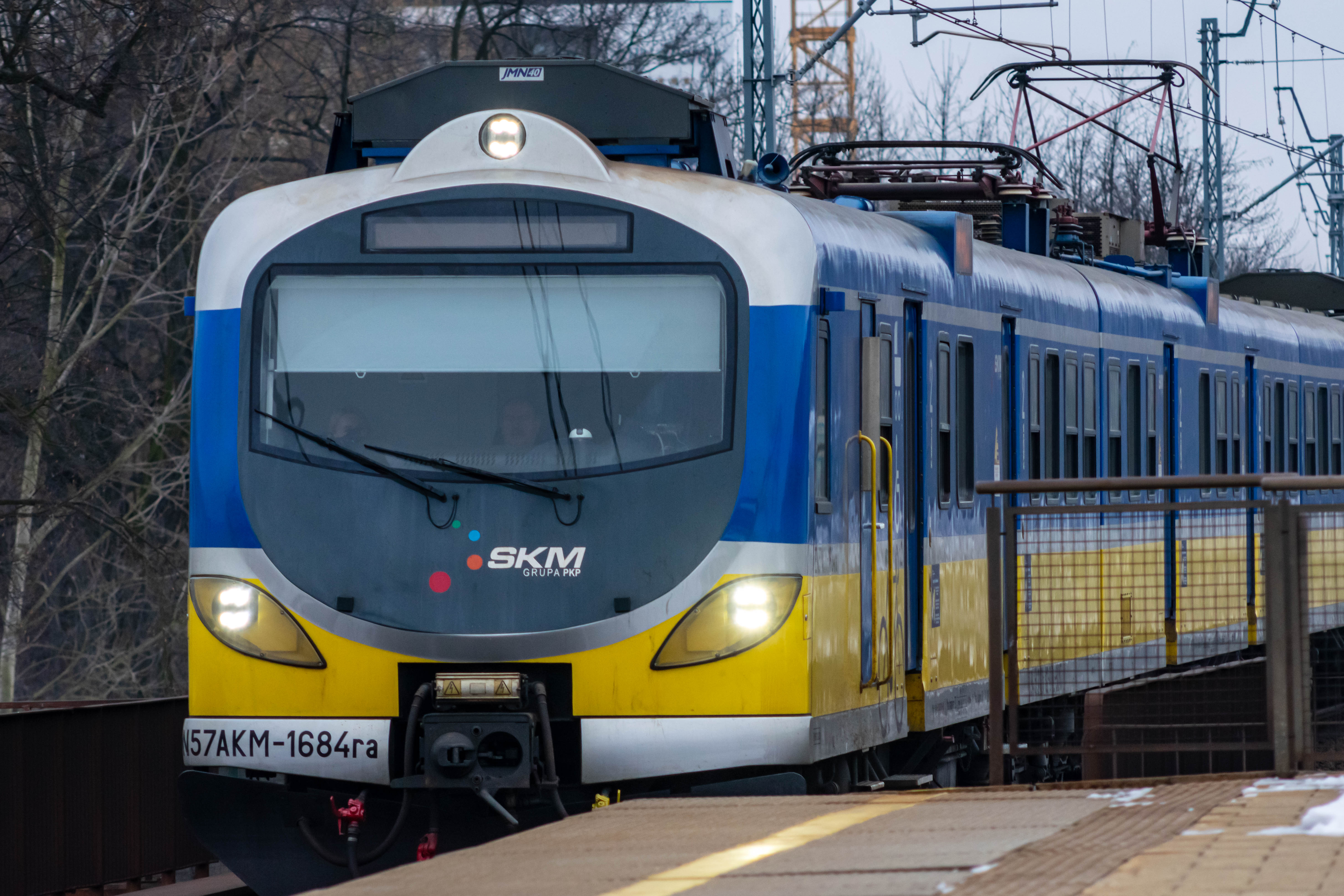 blue-yellow train arriving at the platform