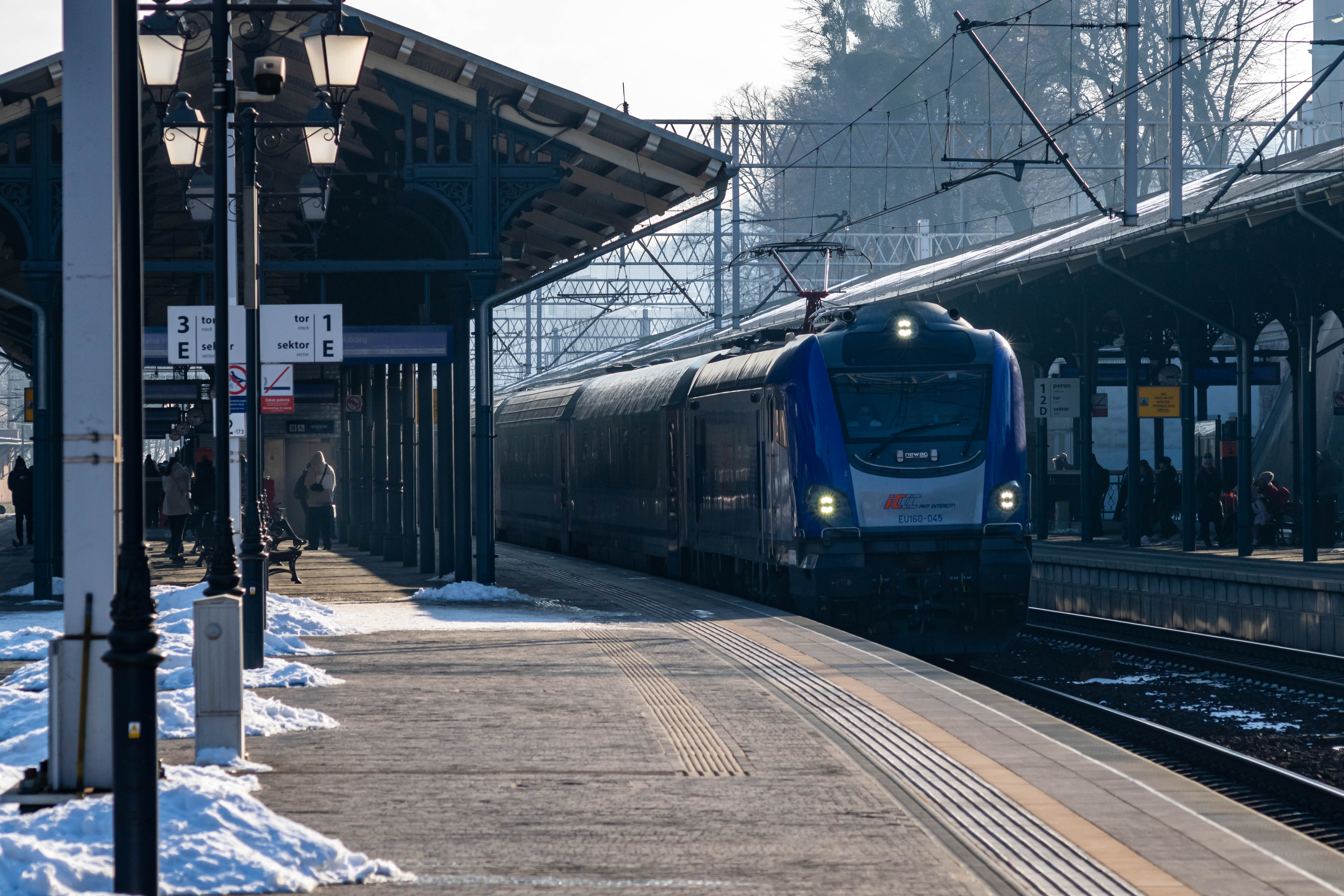 blue-silver locomotive pulling a train