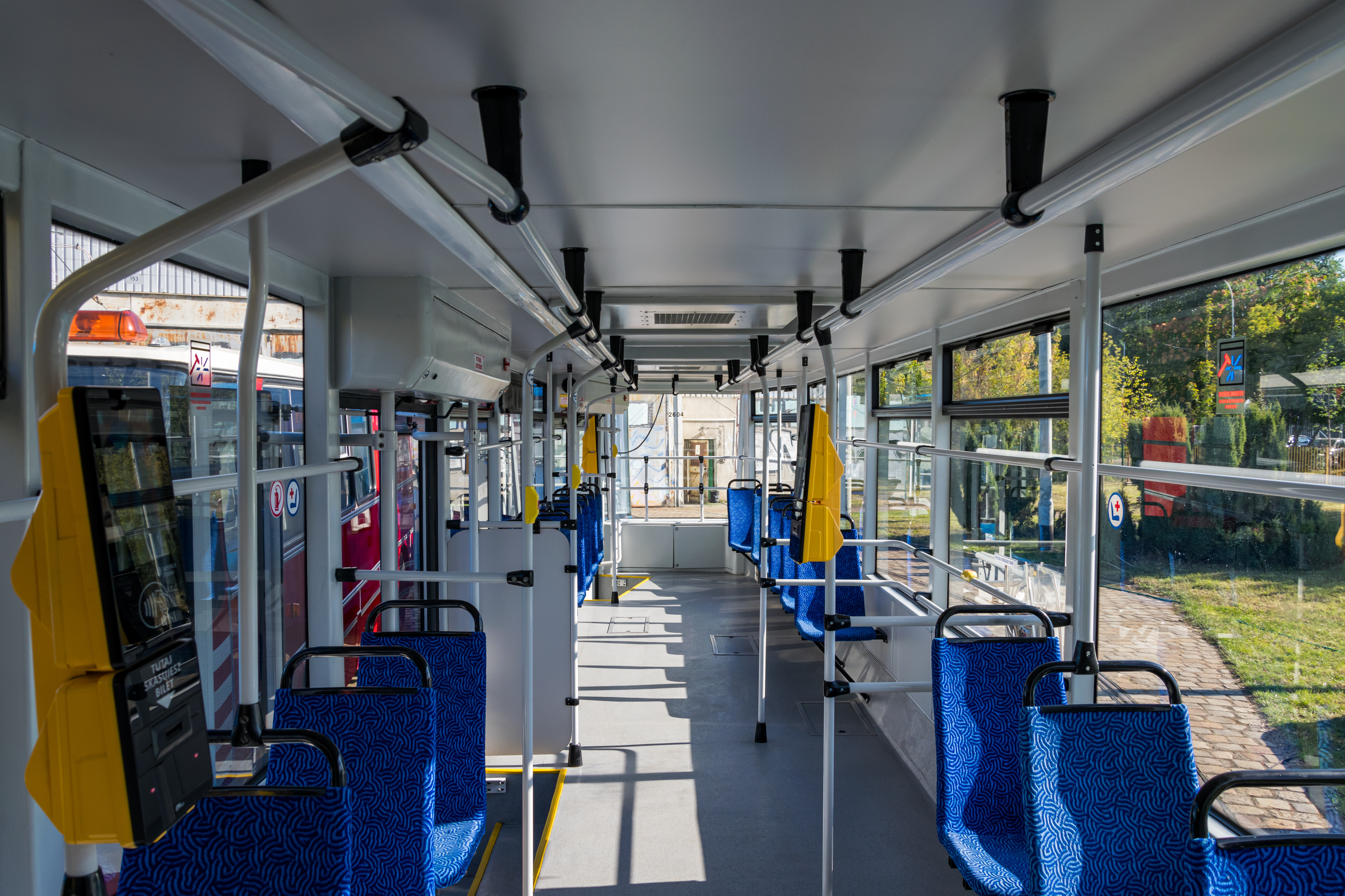 another shot of interior with visible blue seats, white handrails, and large windows