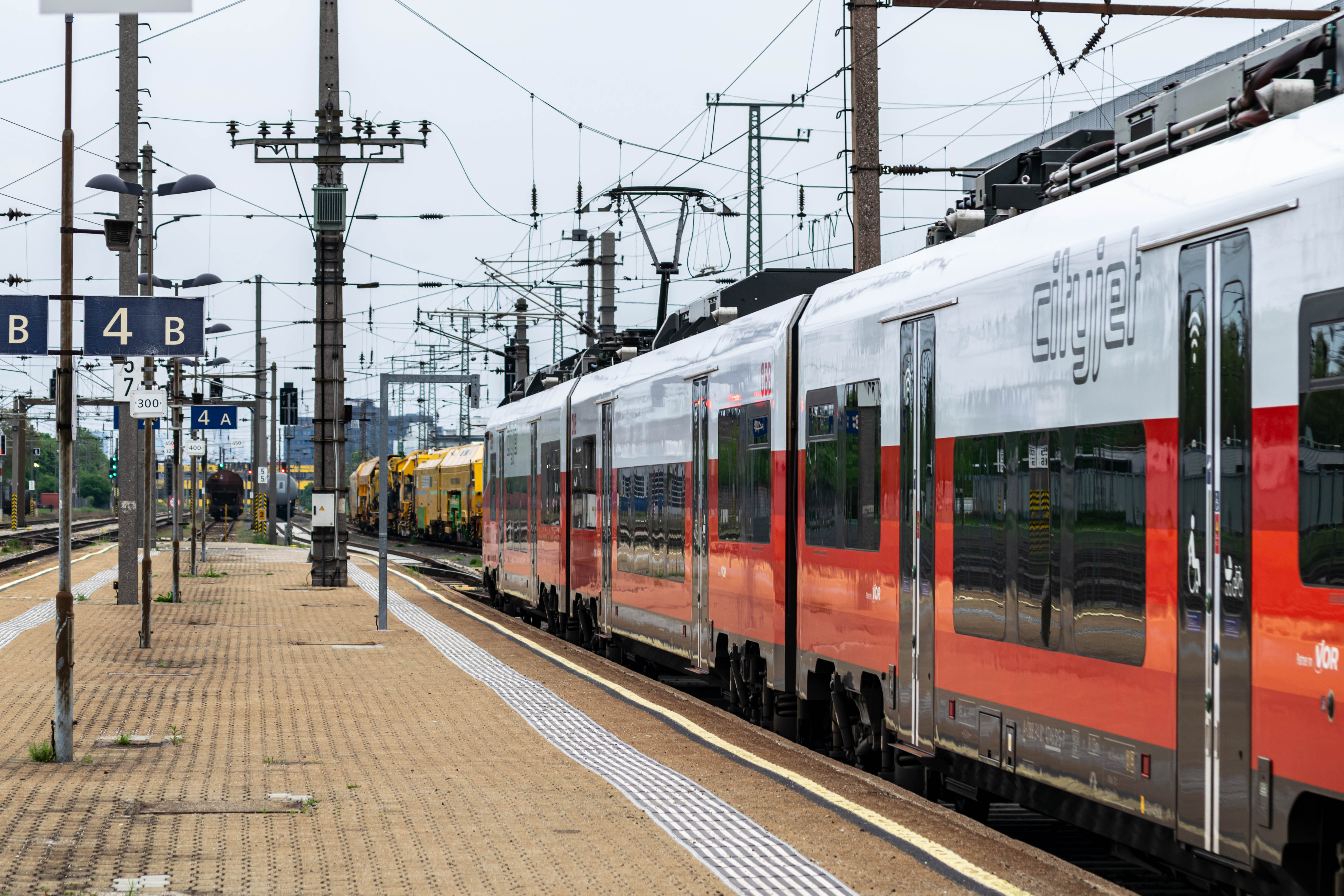 other white-blue train stopped at the platform, viewed from the side