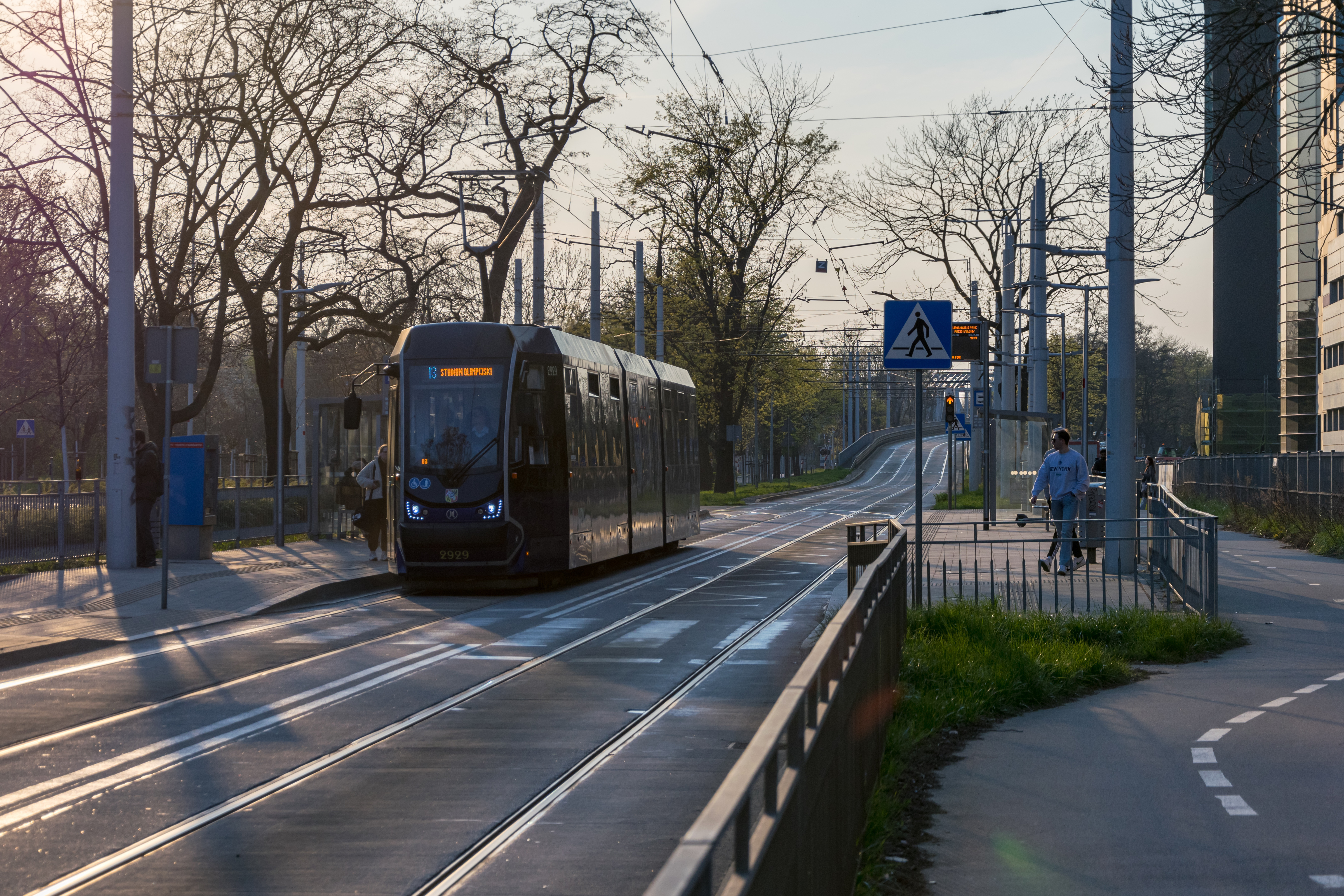 Dark-blue tram at a stop