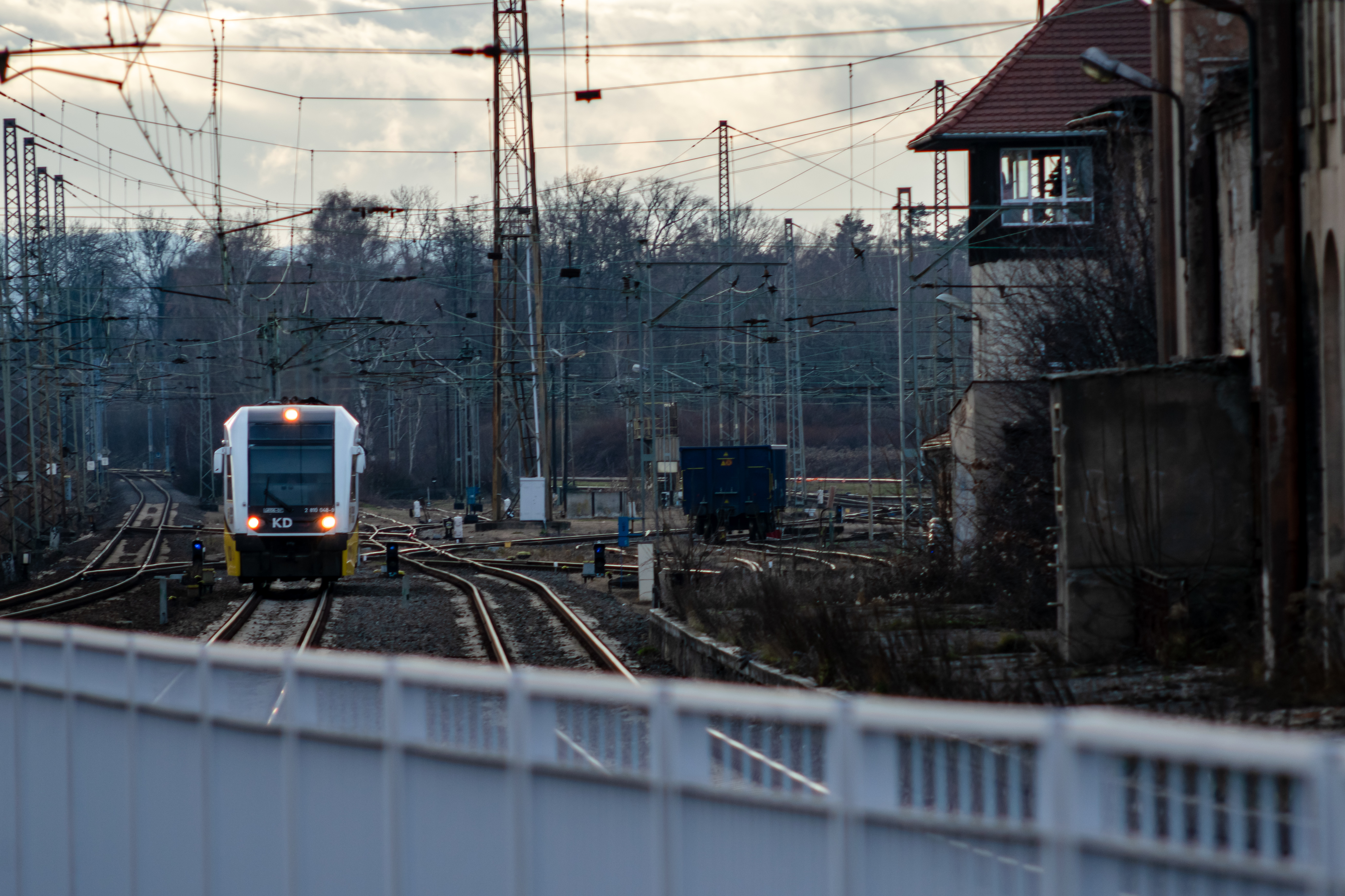 yellow-black-white motor car entering the station