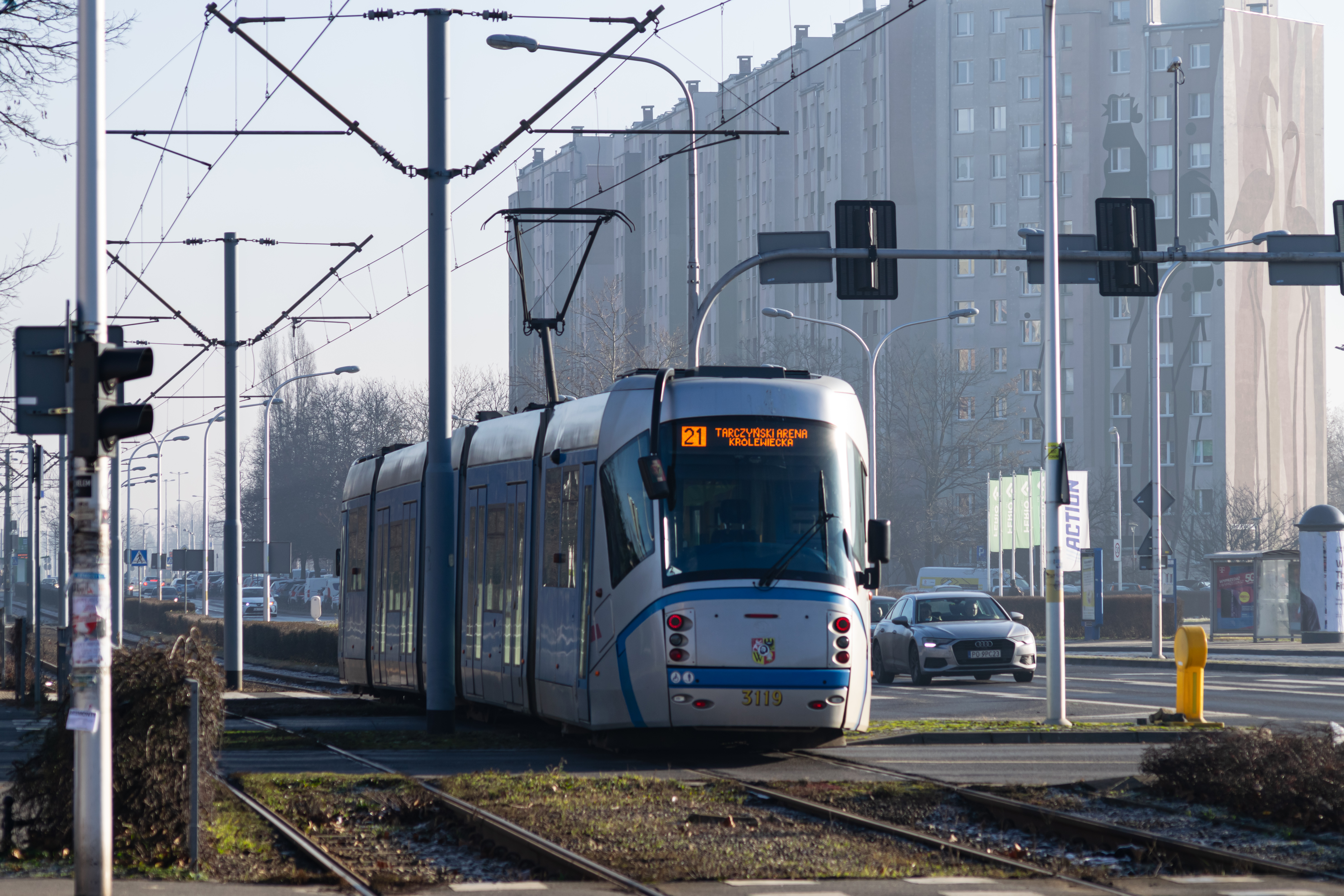 silver-blue tram departing from a starting stop