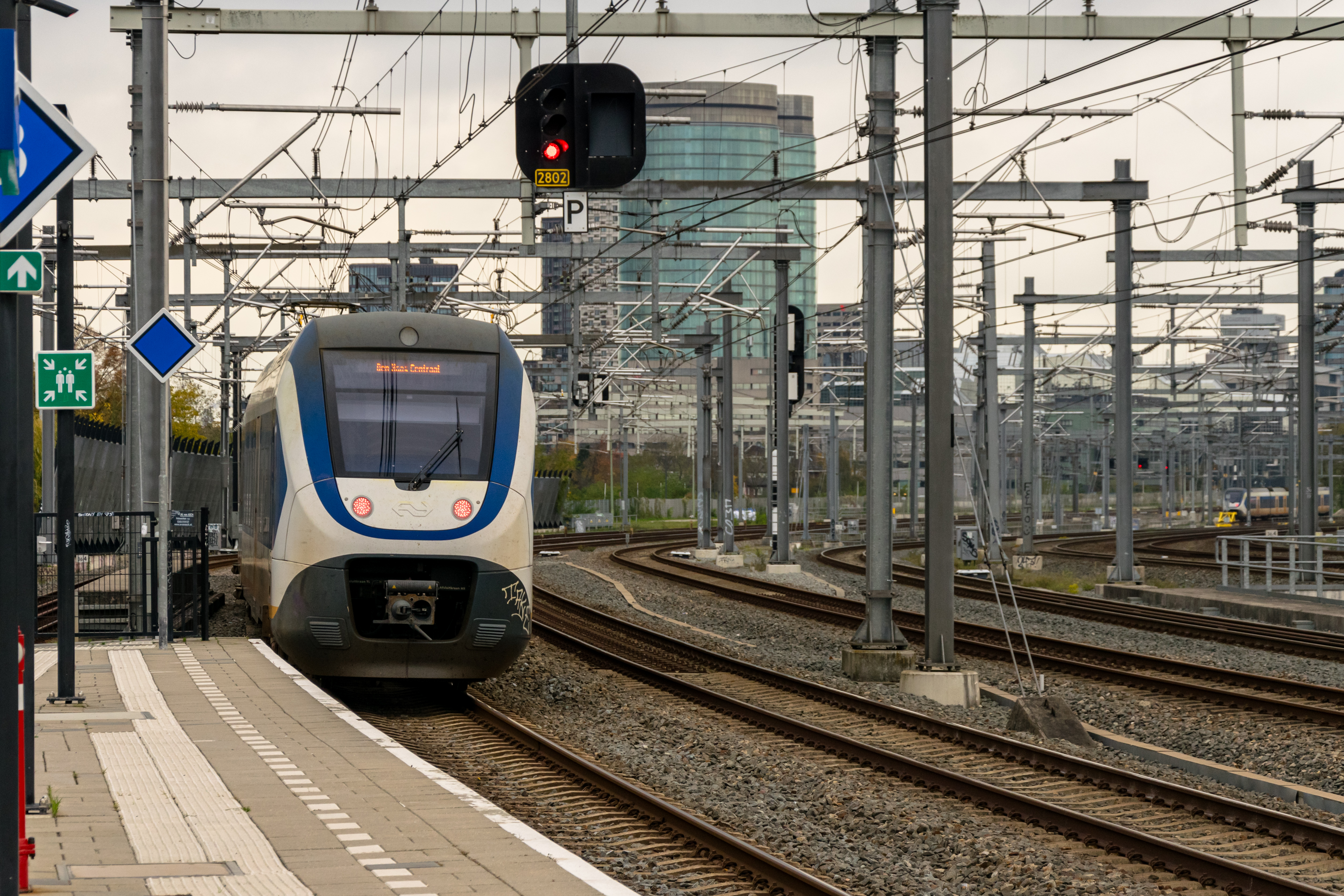 white-blue train leaving the station