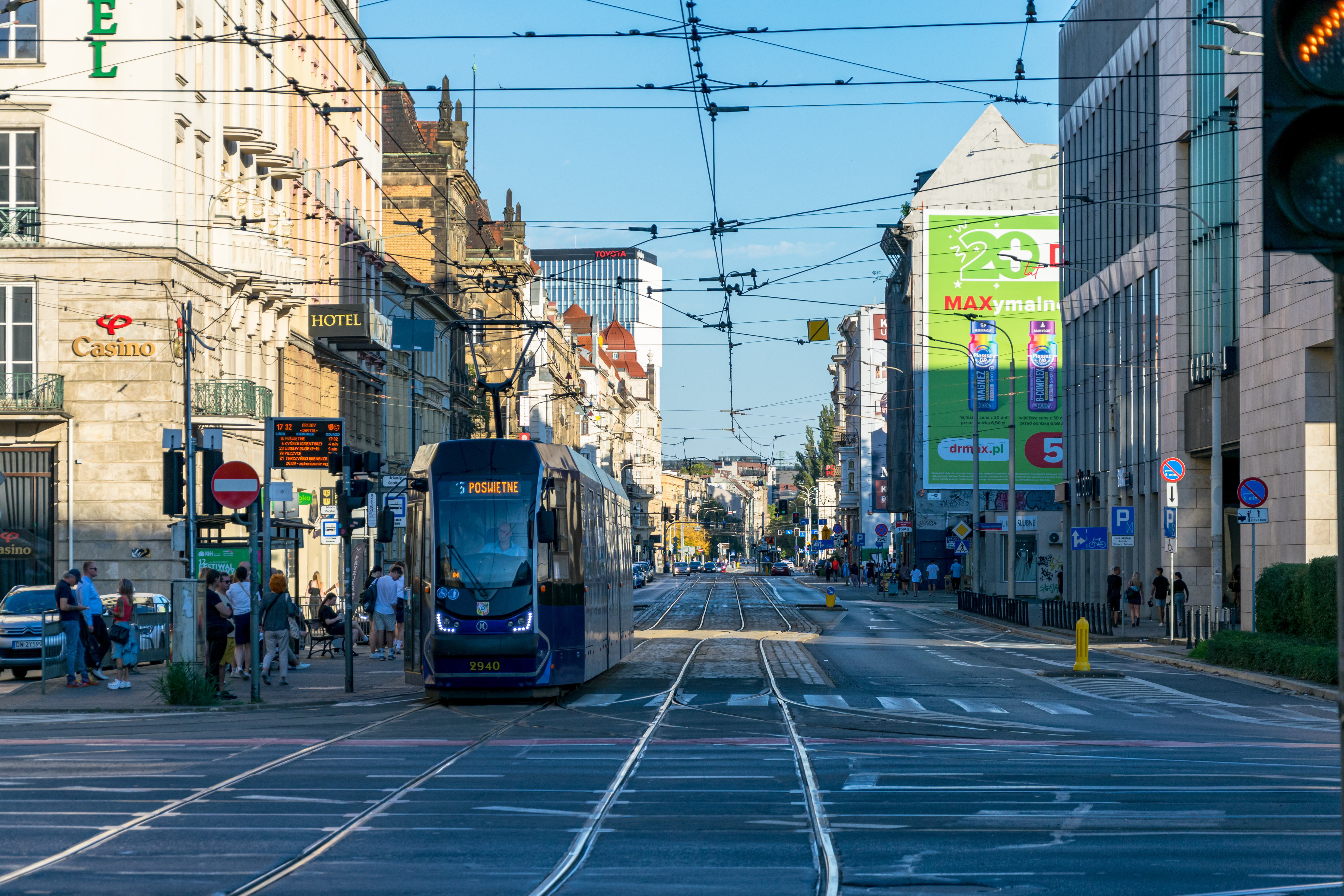 dark-blue tram on background of multiple old buildings