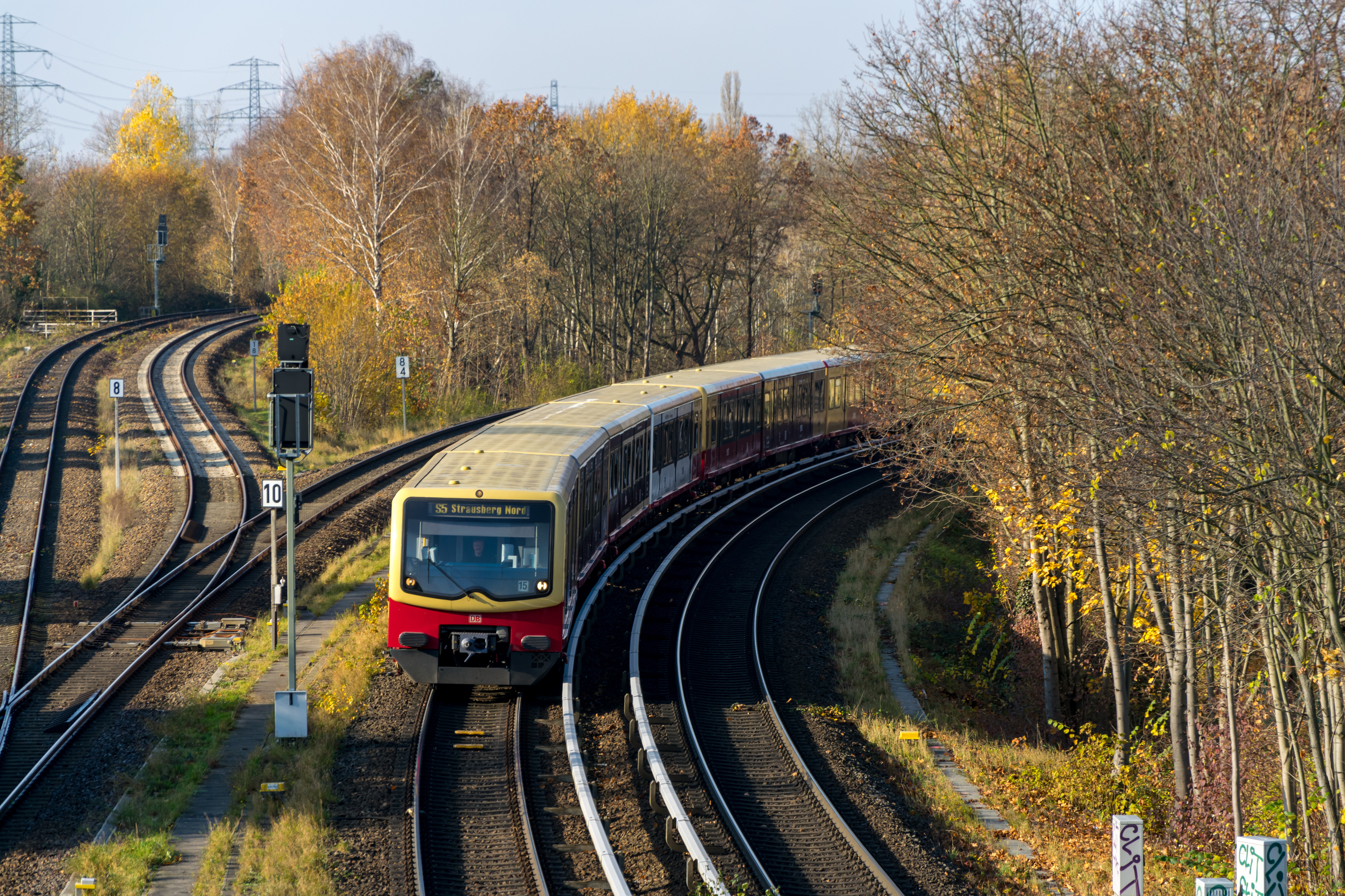 Yellow-red s-bahn train taking a curve