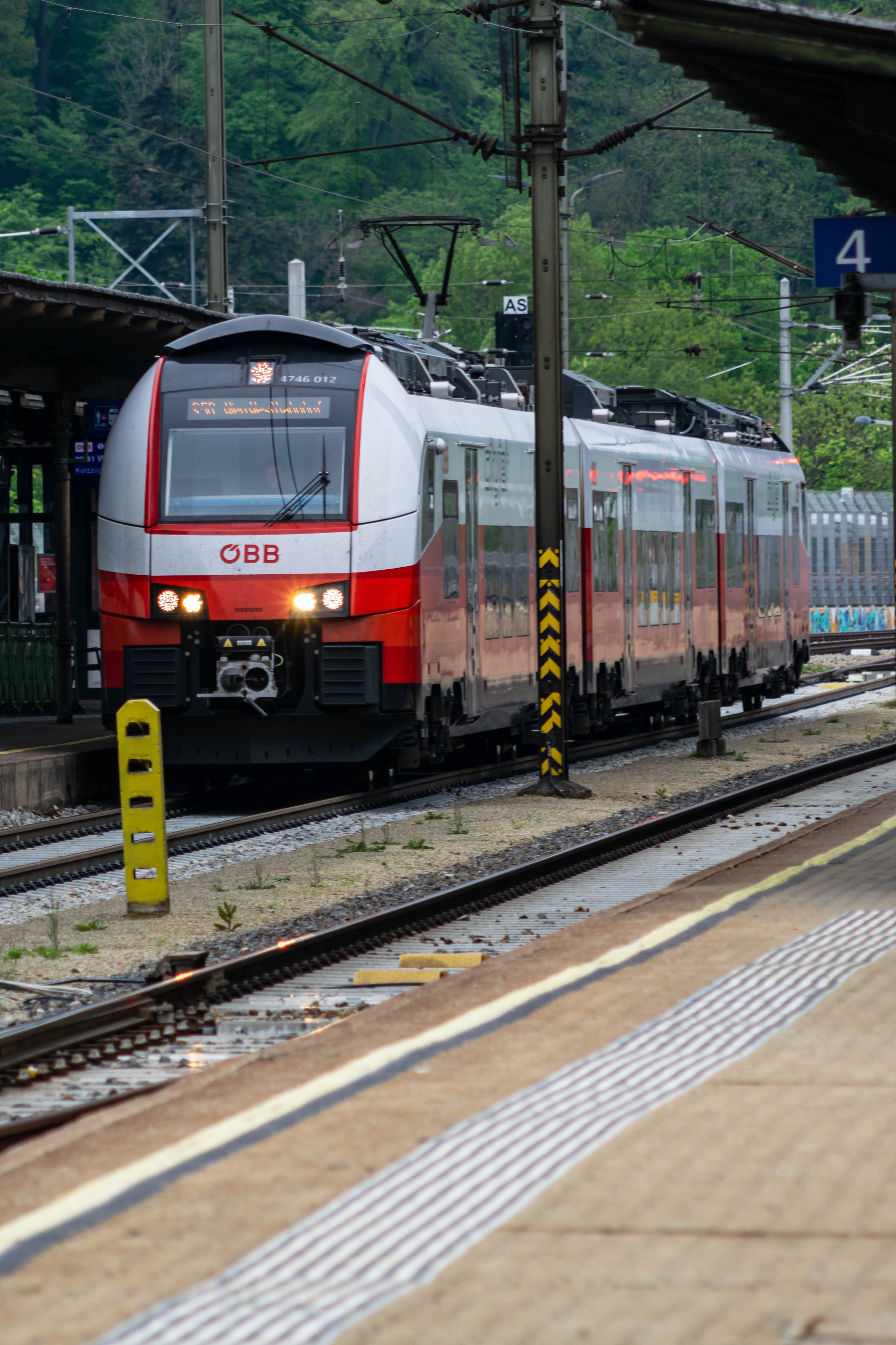 white-red train stopped at the platform