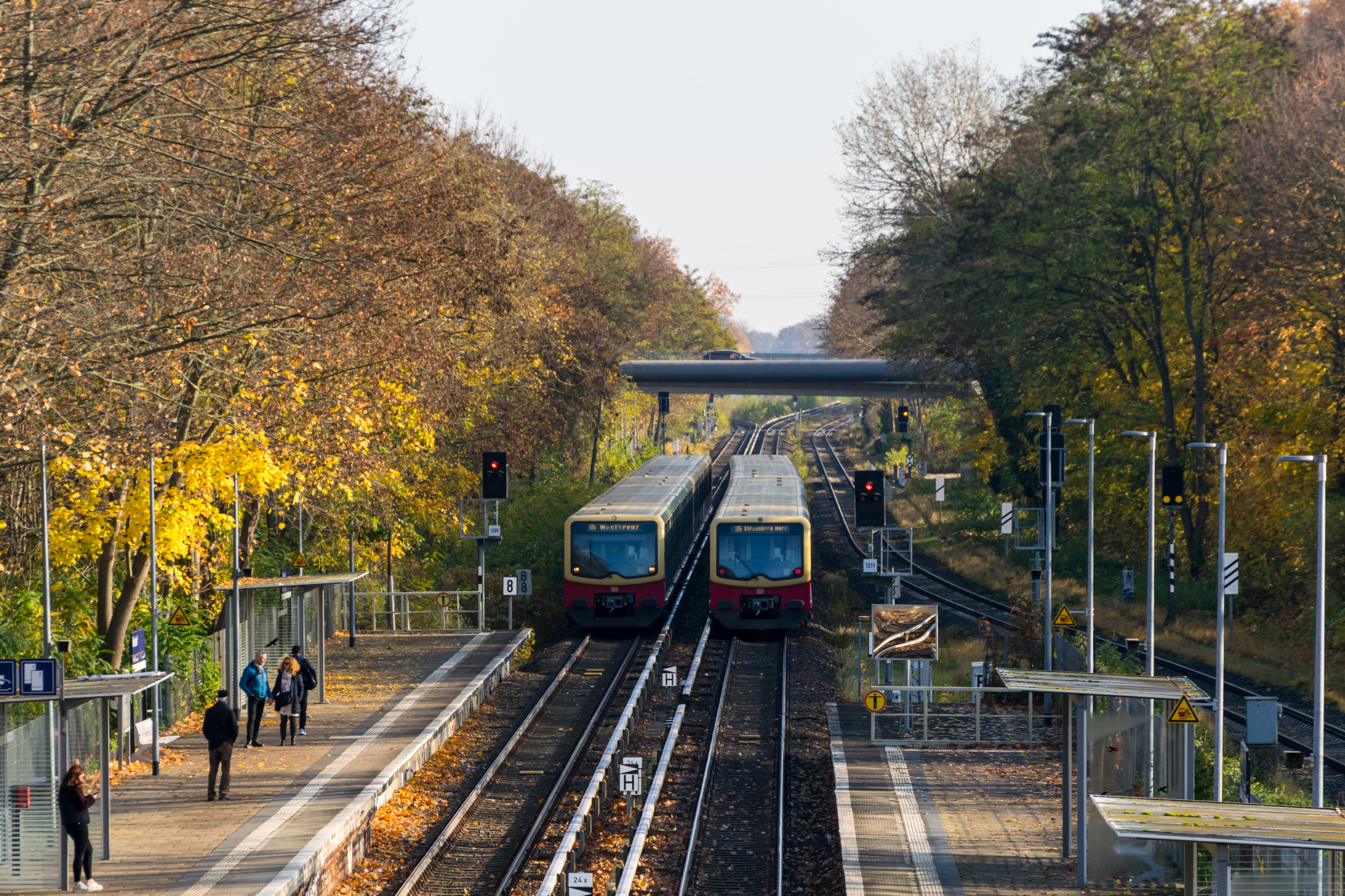 Two yellow-red s-bahn trains going past each other