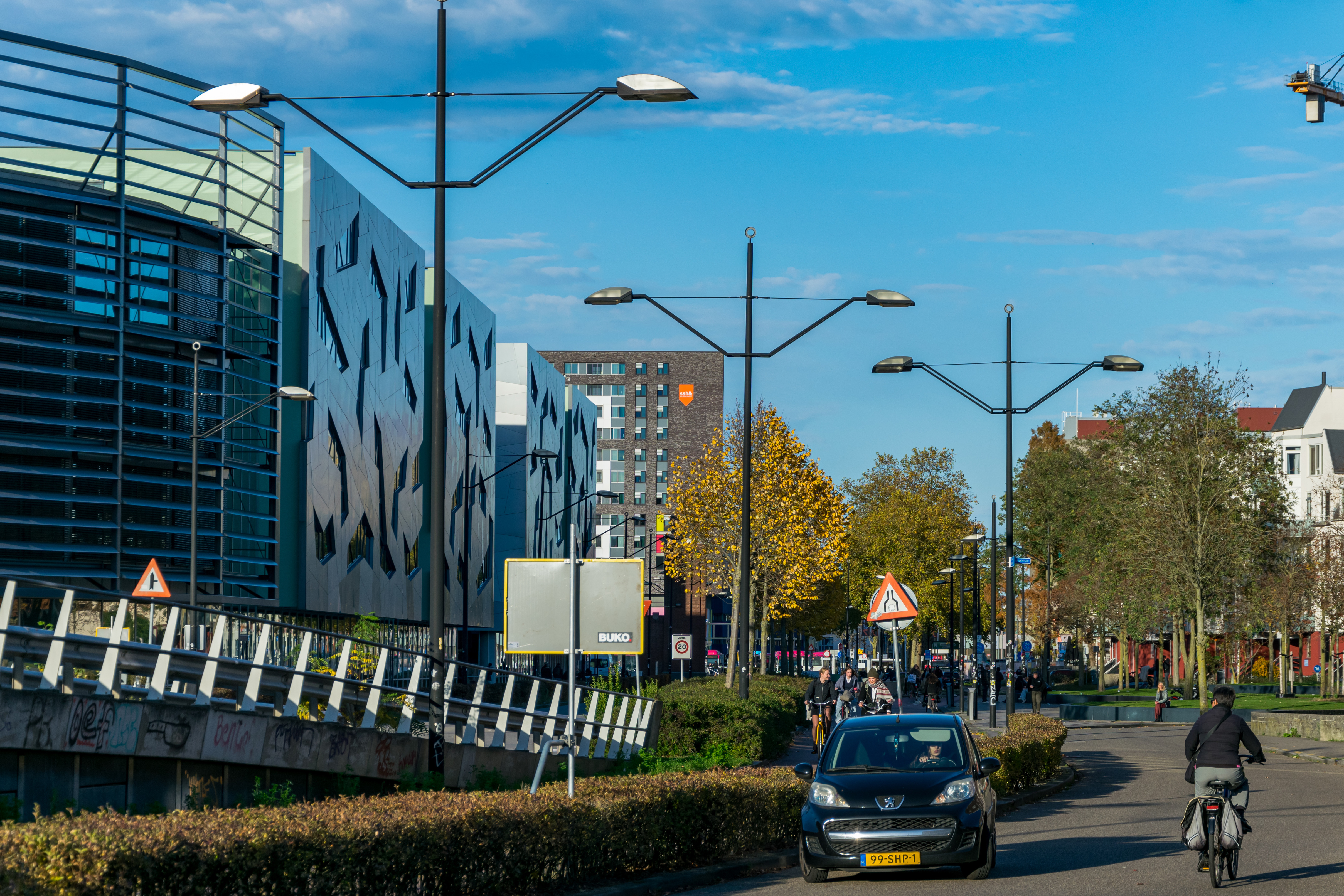 Street lights that kind of look like poles for overhead line equipment on tram lines