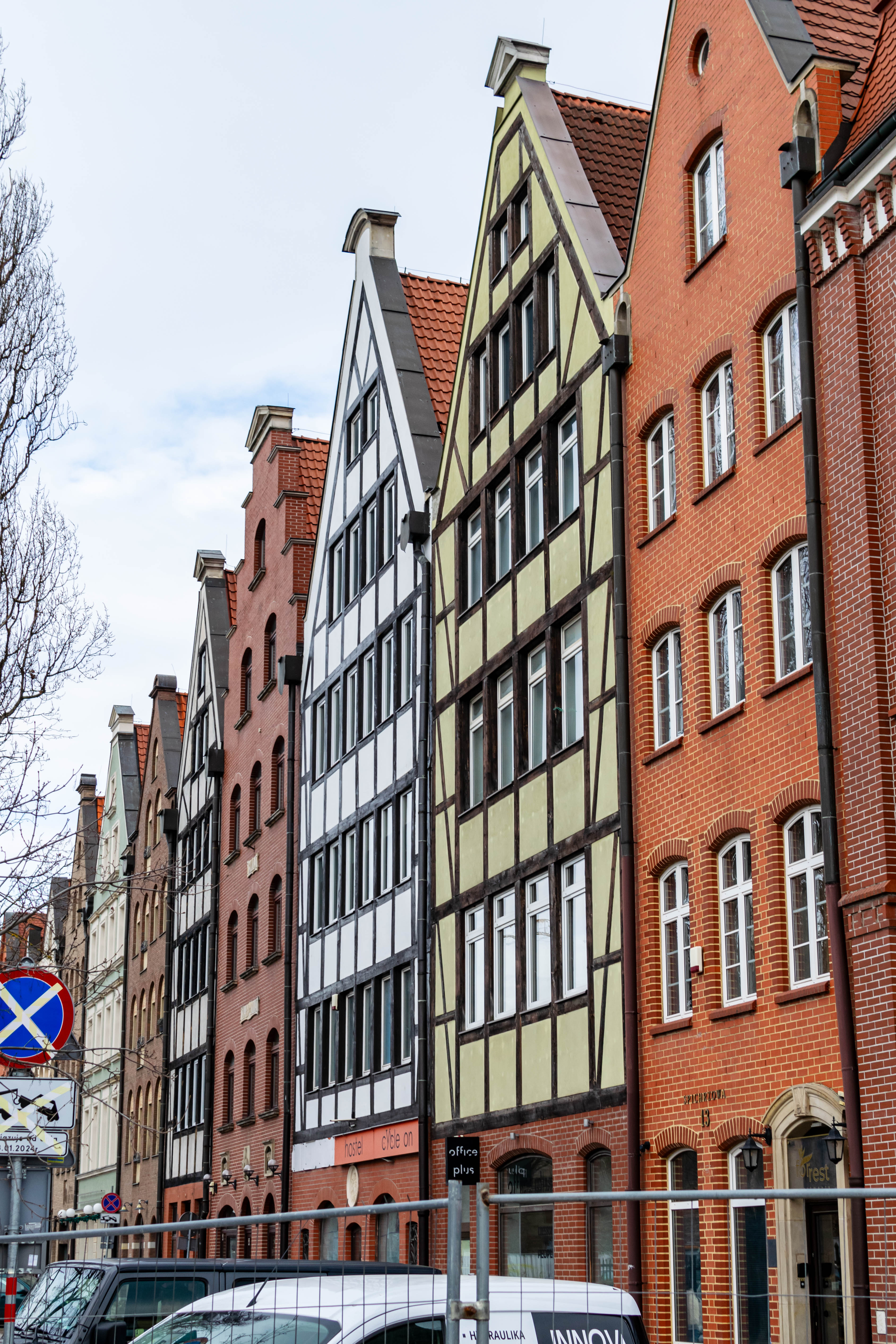 a bunch of colorful townhouses next to a street