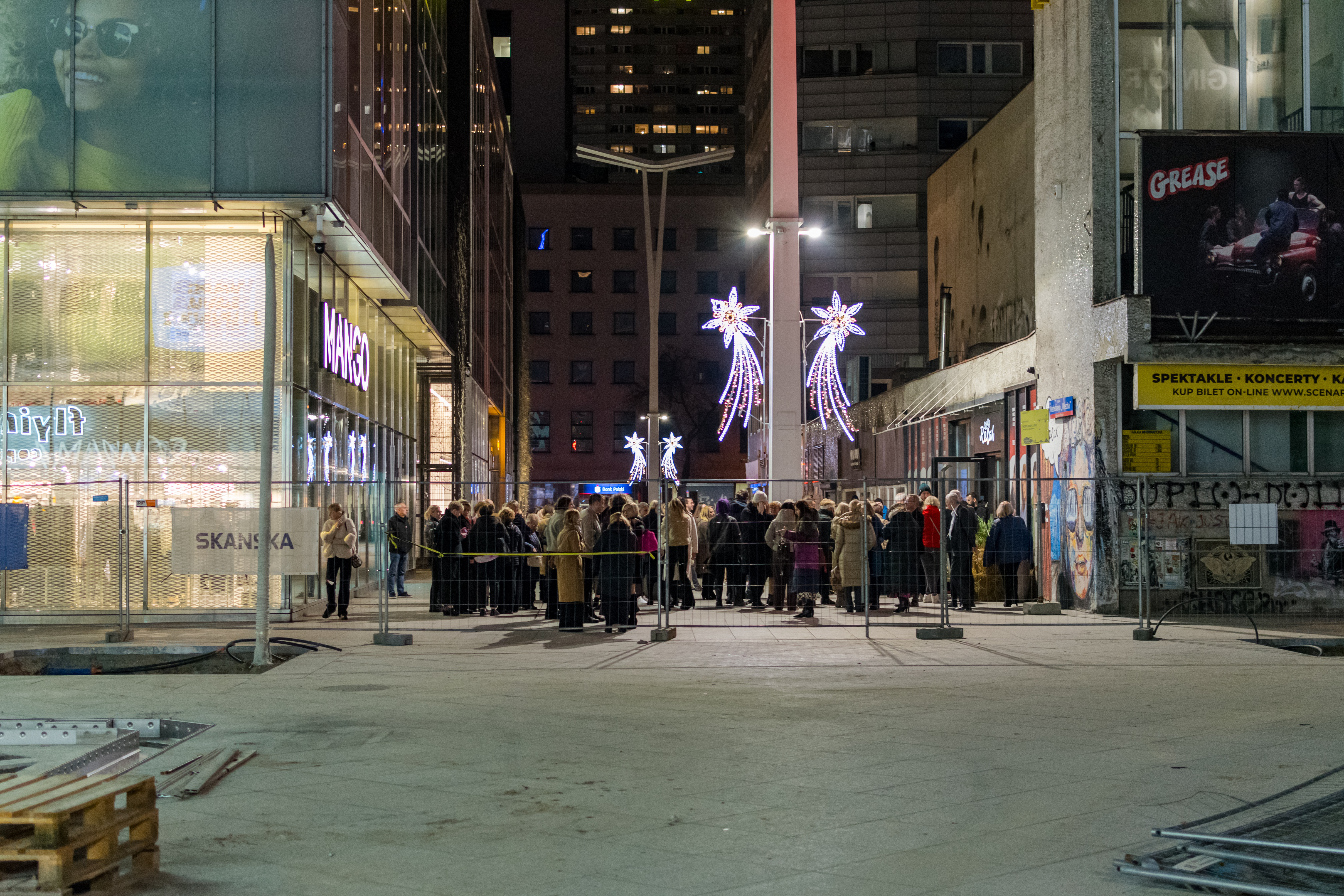 Crowd of people behind bars or something