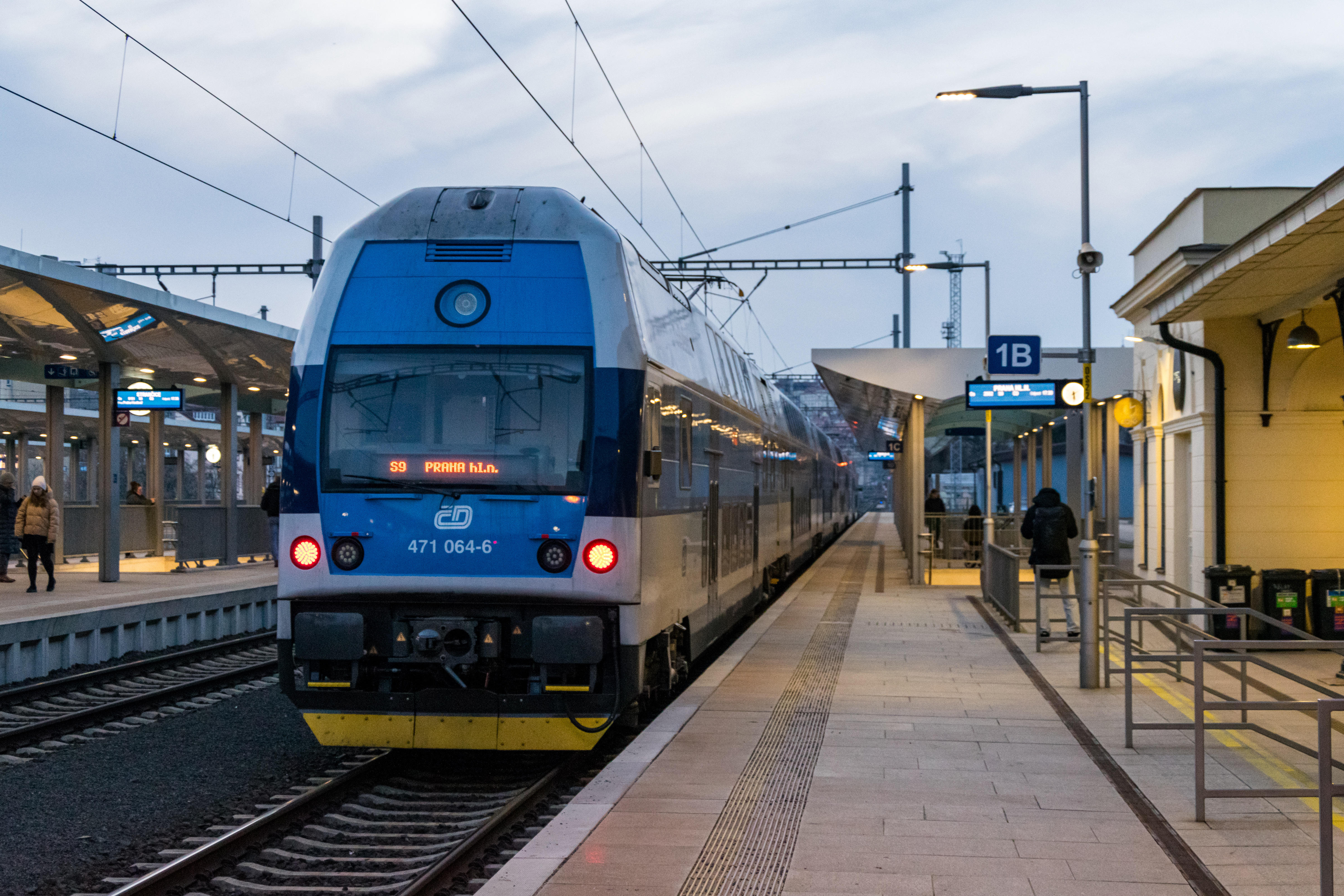 white-blue double-decker train stopped at a platform