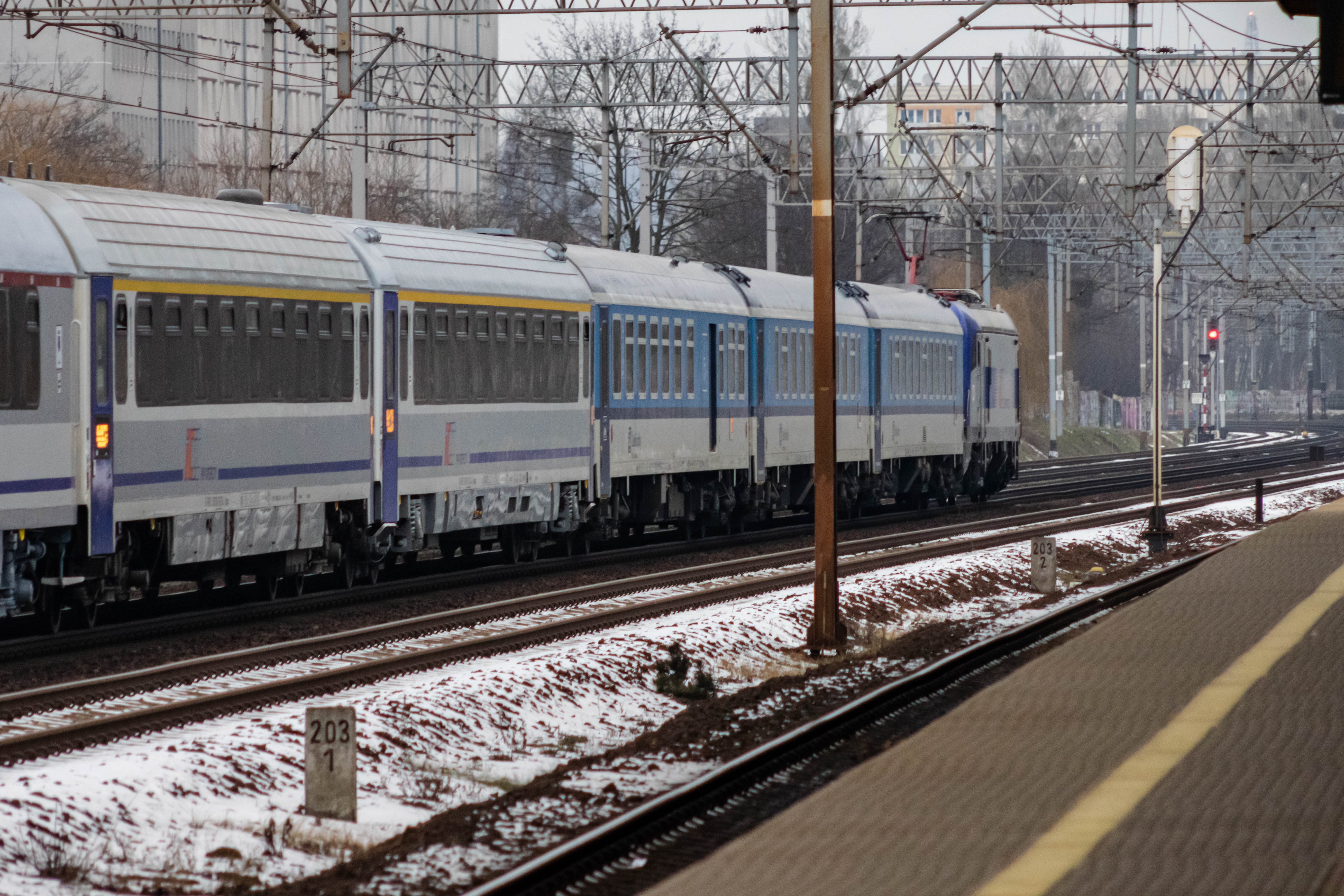 silver-blue locomotive pulling blue-white and silver-blue coaches