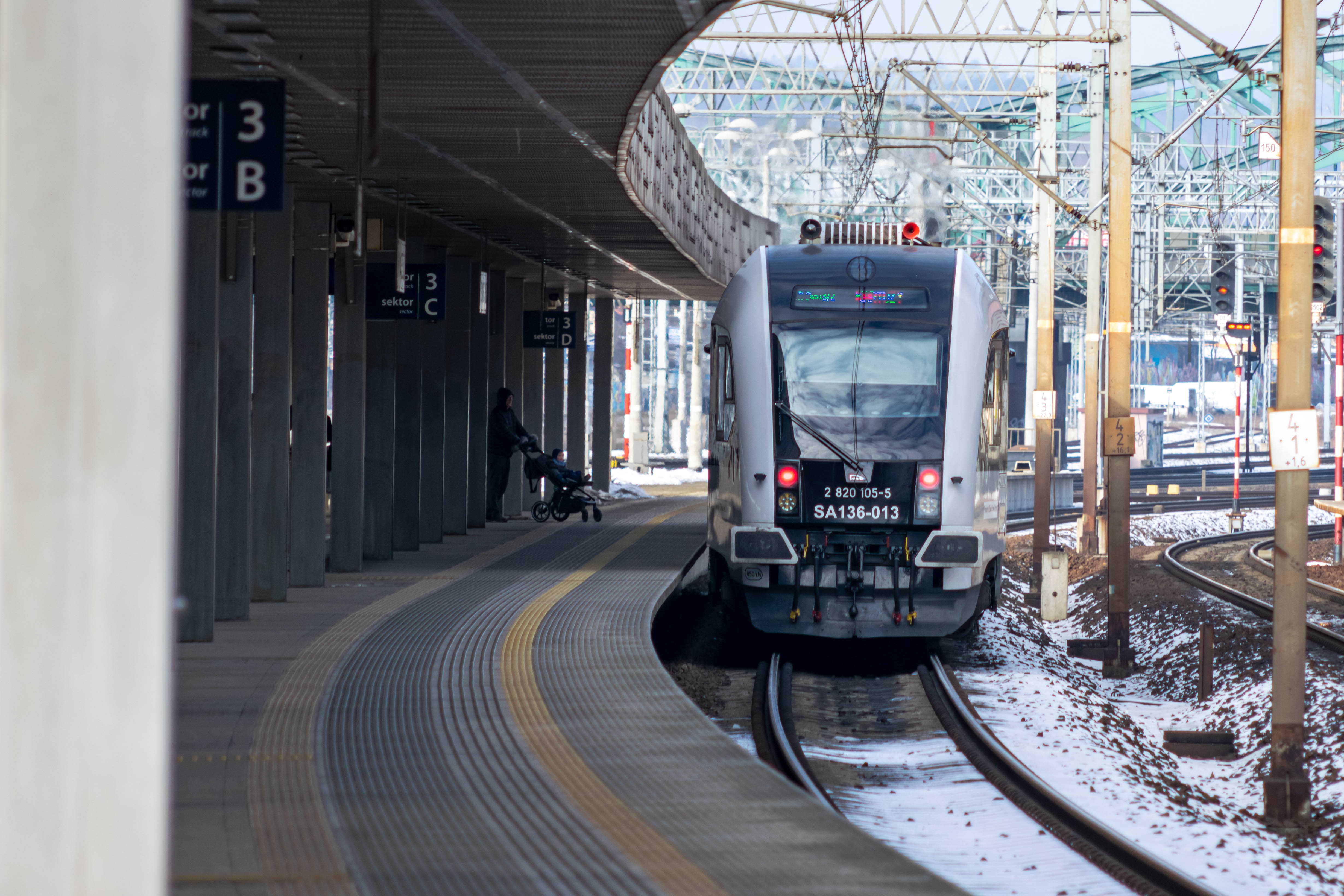 white-black train standing at a platform