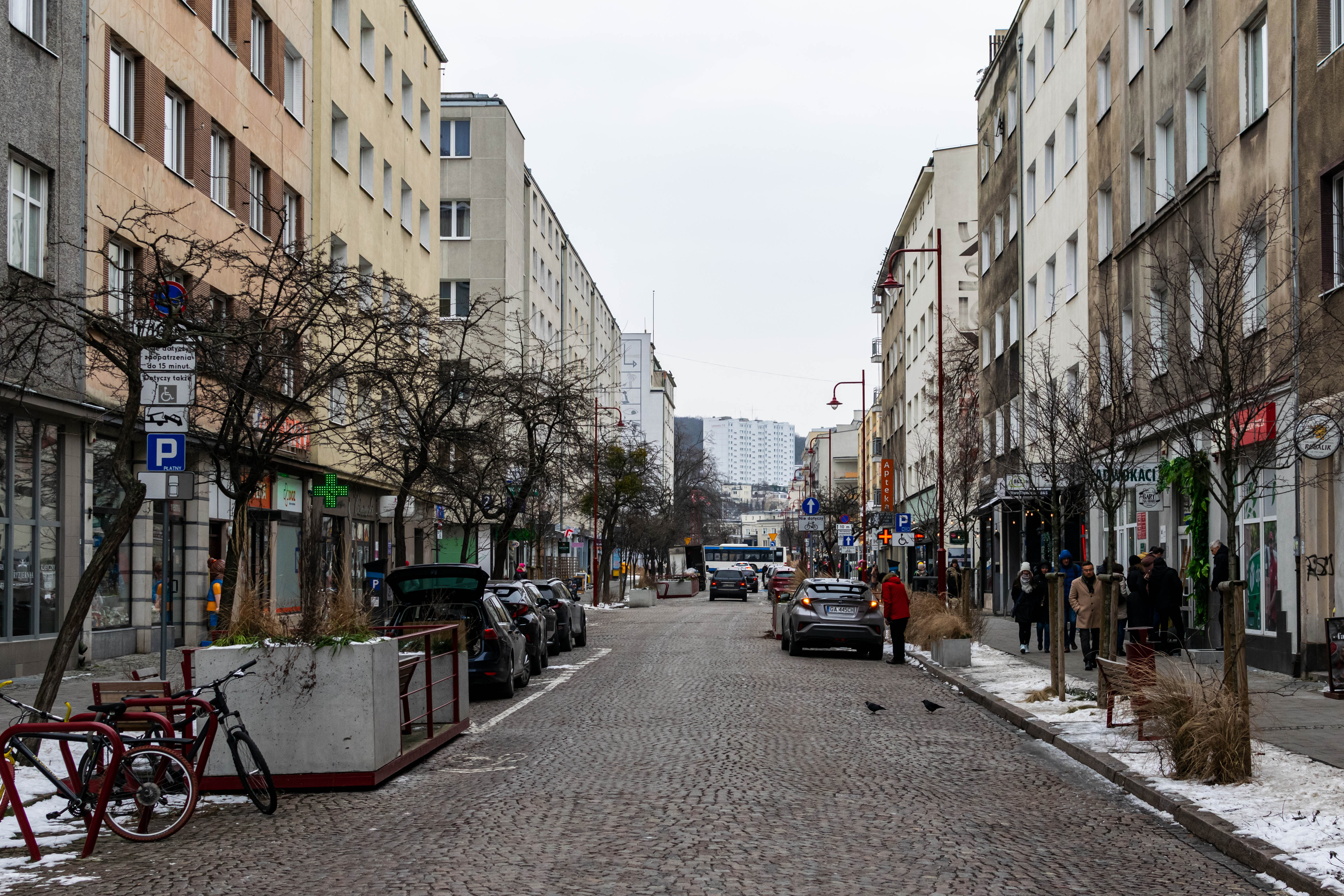 cobbled street with buildings from various eras on both sides