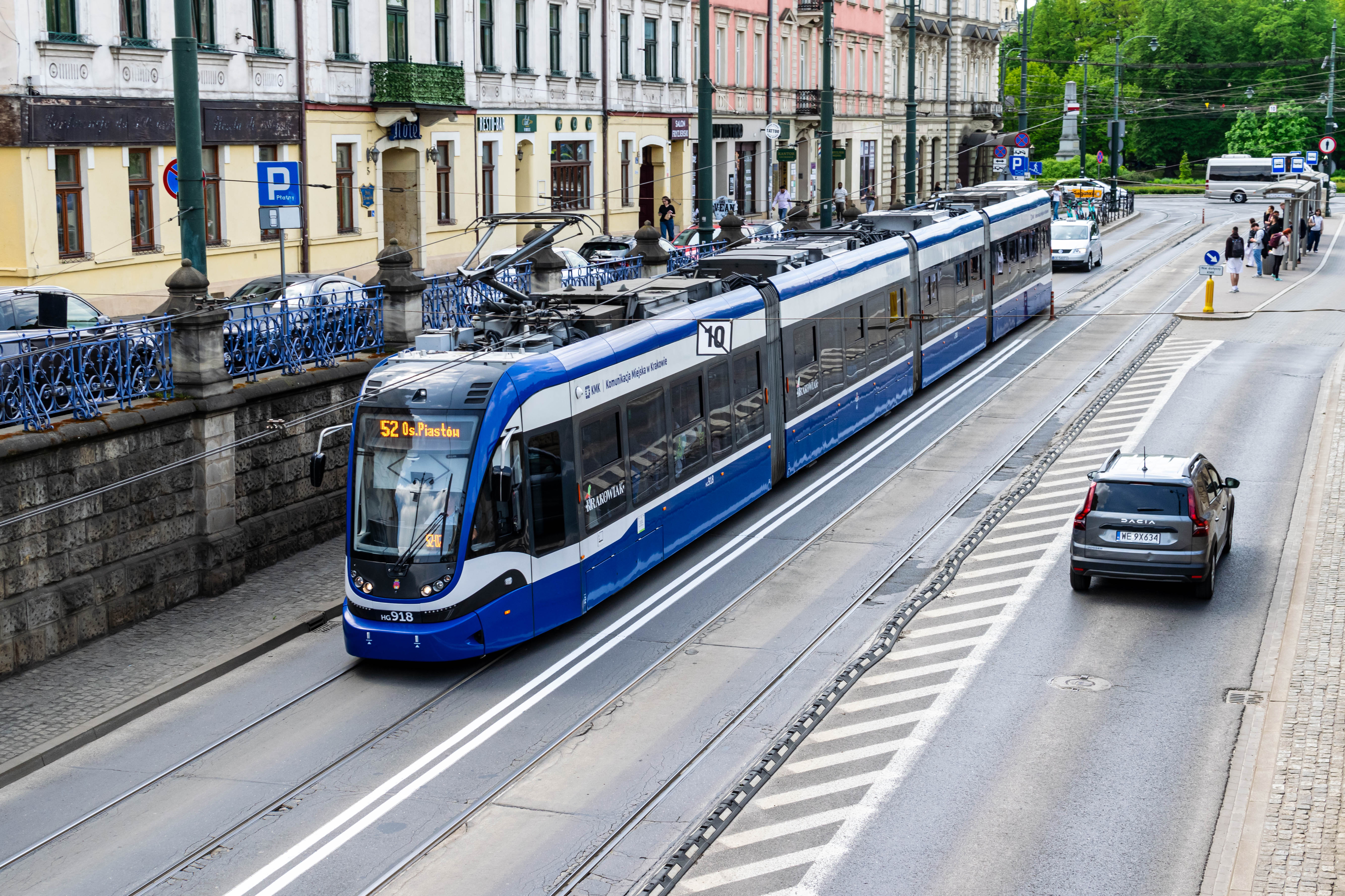 Blue-white tram in a trench in old town