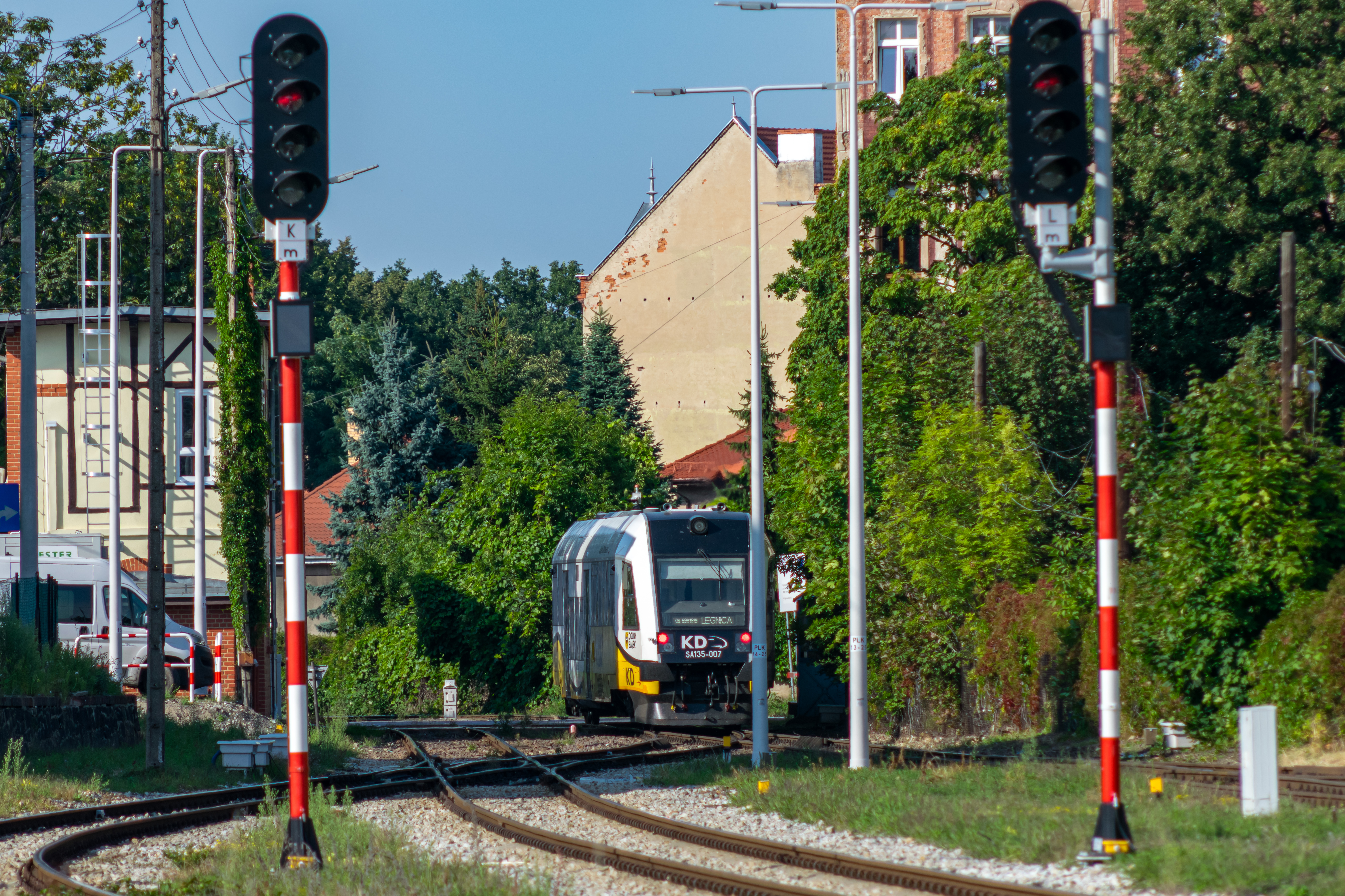 short white-yellow train leaving the station