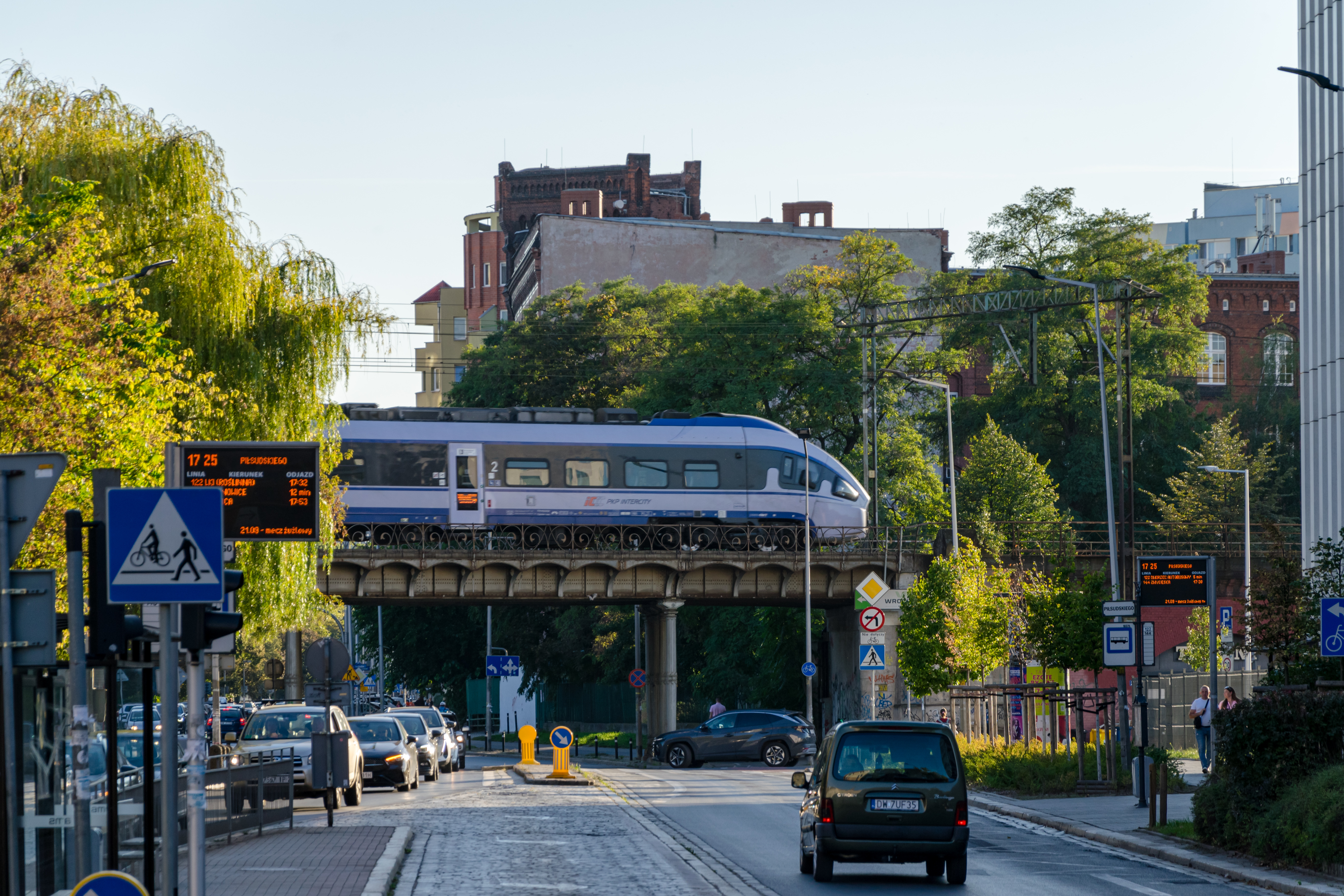 train with carp-shaped front on a viaduct over a street