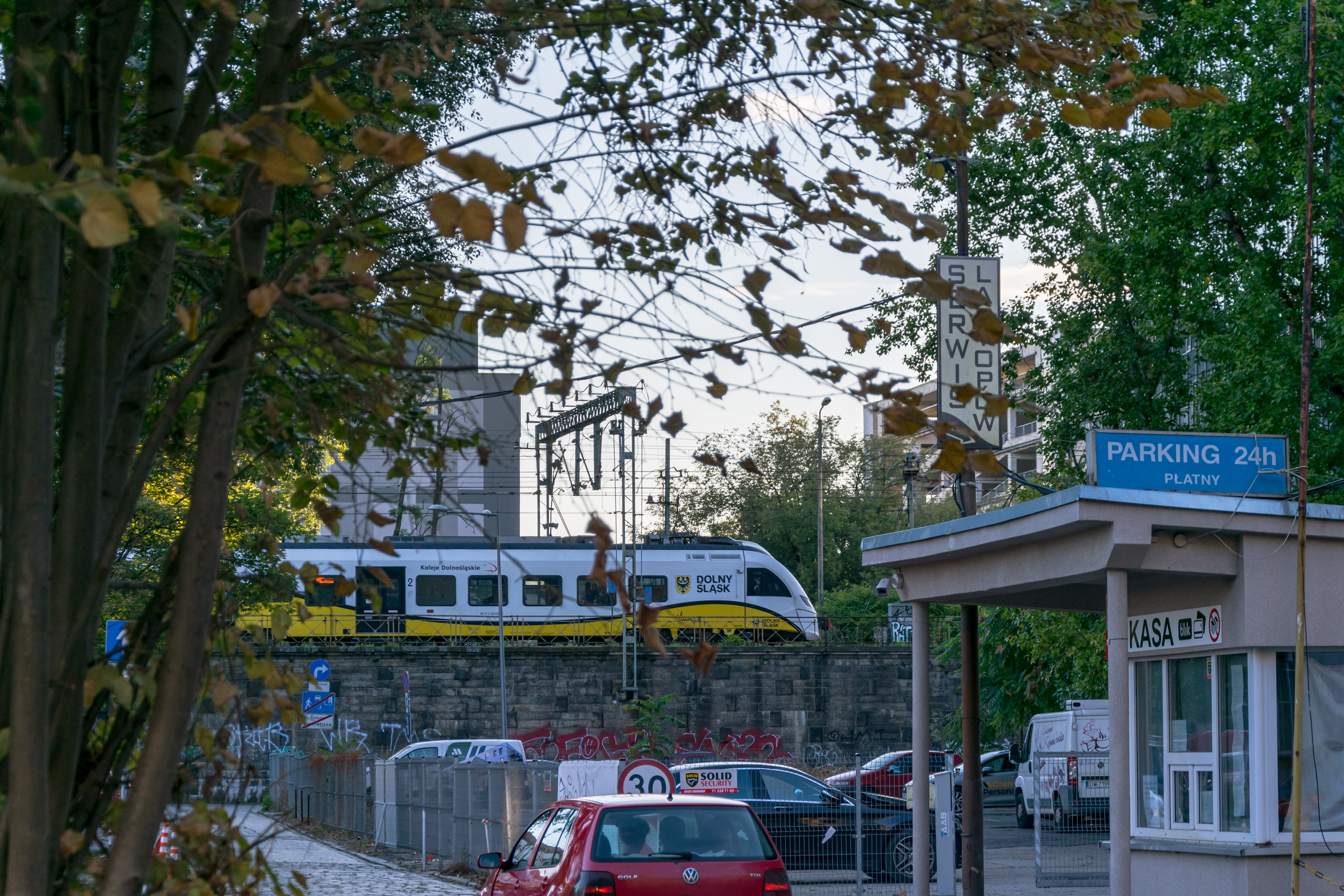 yellow-white train on a viaduct