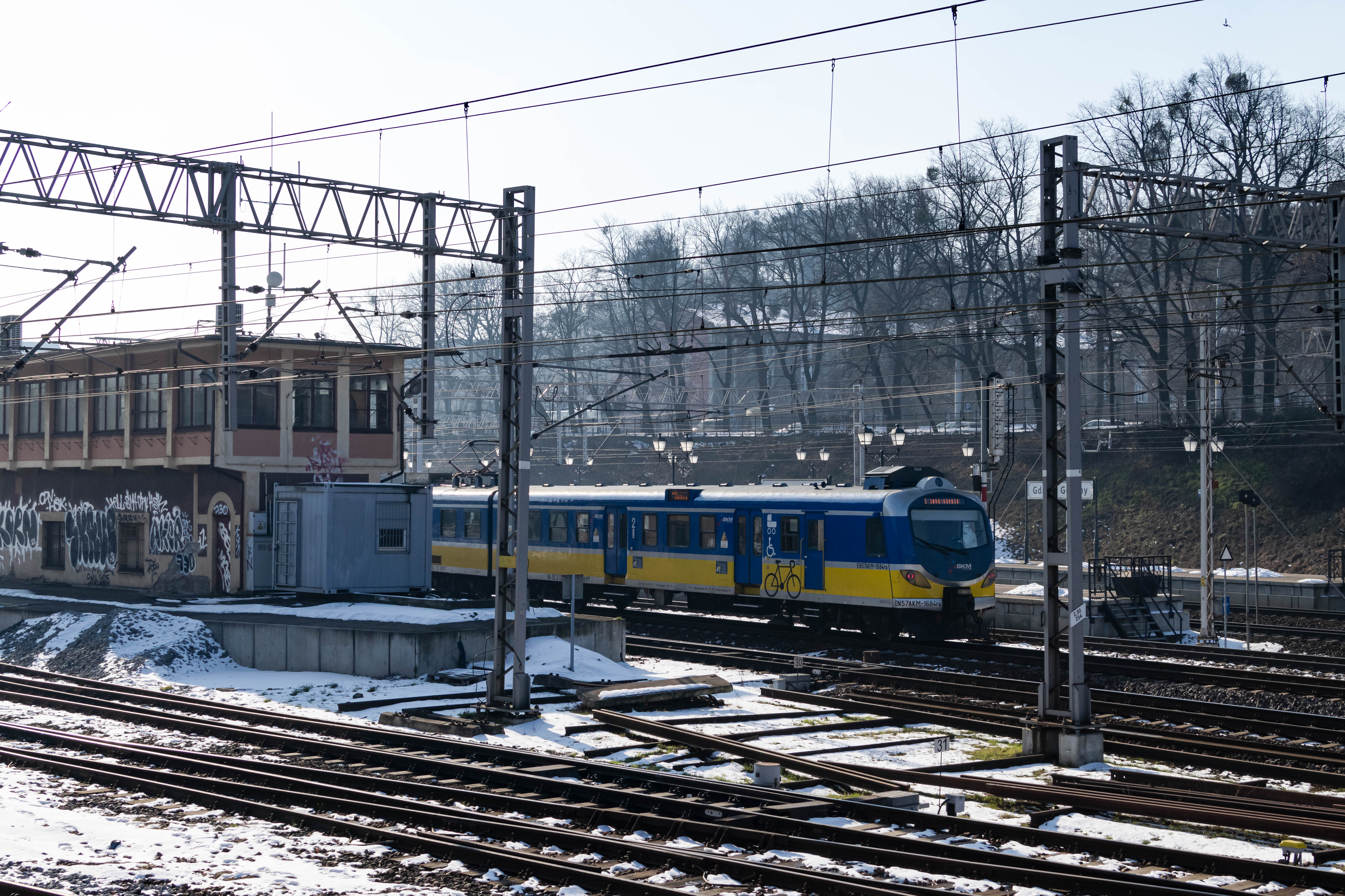 blue-yellow train arriving at the station