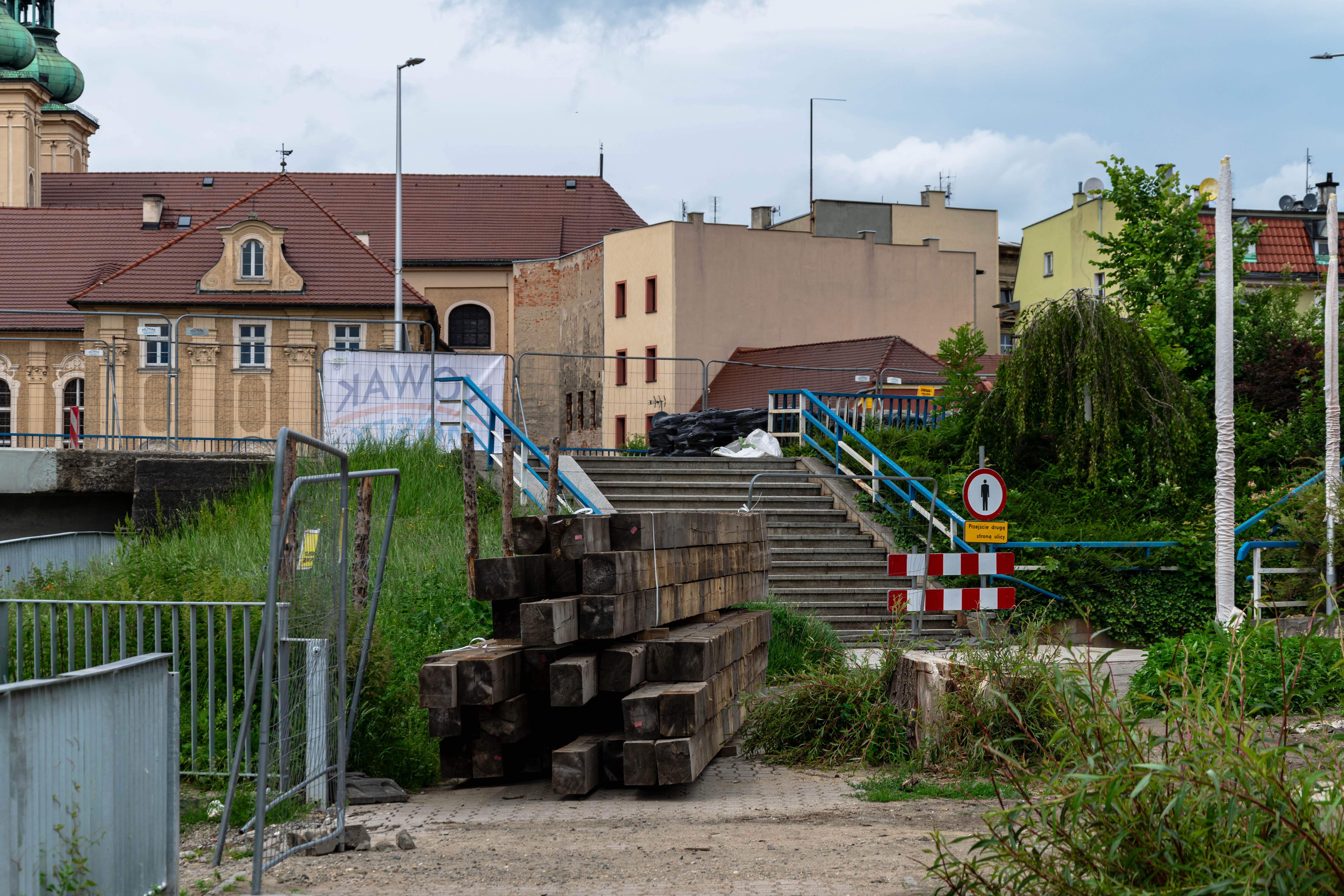 a bunch of wooden planks on a path that has fallen into disrepair