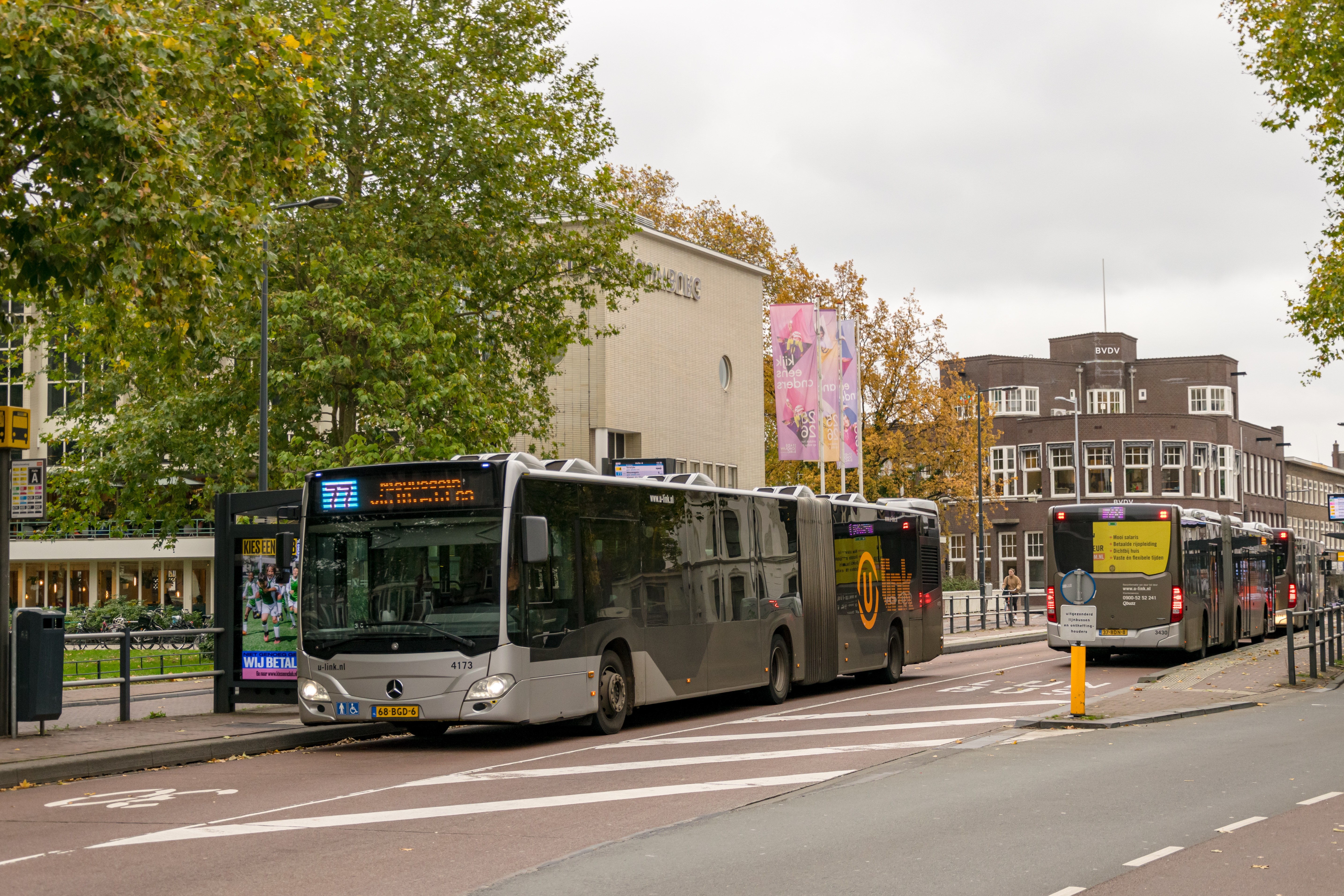 two silver articulated buses