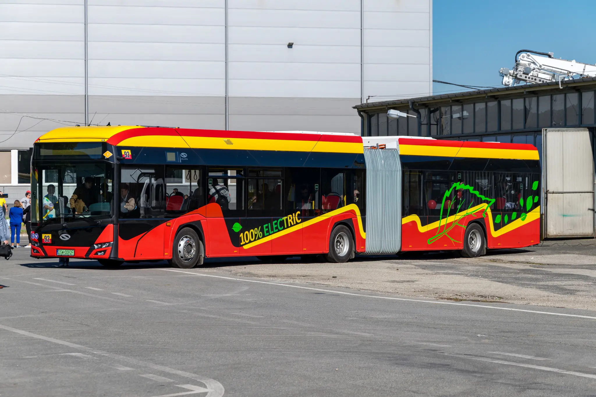 Different yellow-red Solaris Urbino 18 electric articulated bus but this livery is wavy and has a big leaf at the back