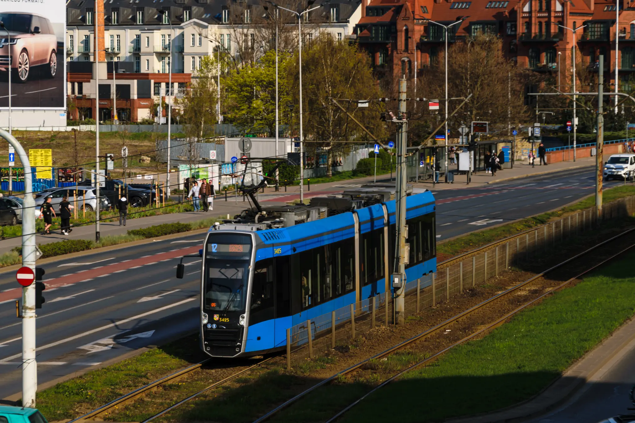 Light-blue tram on grass track
