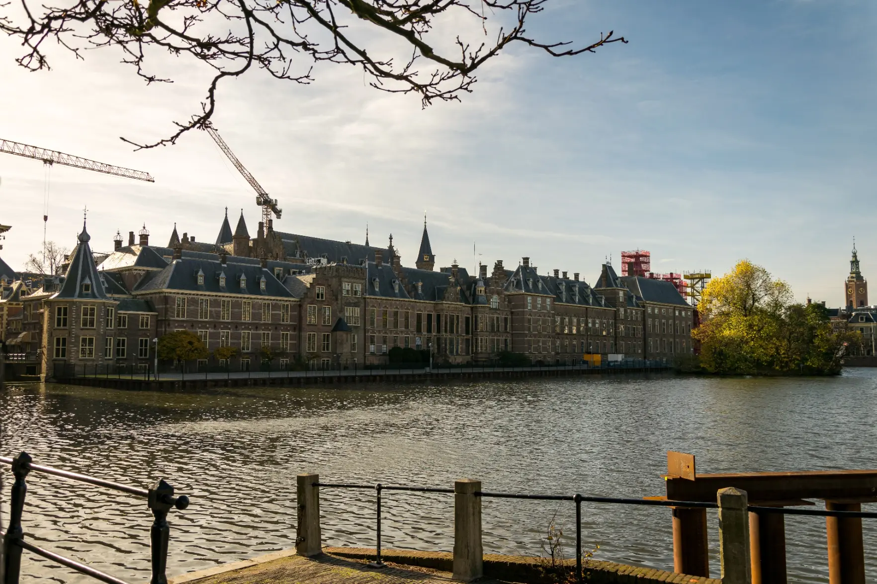 big fancy brick building near a pond