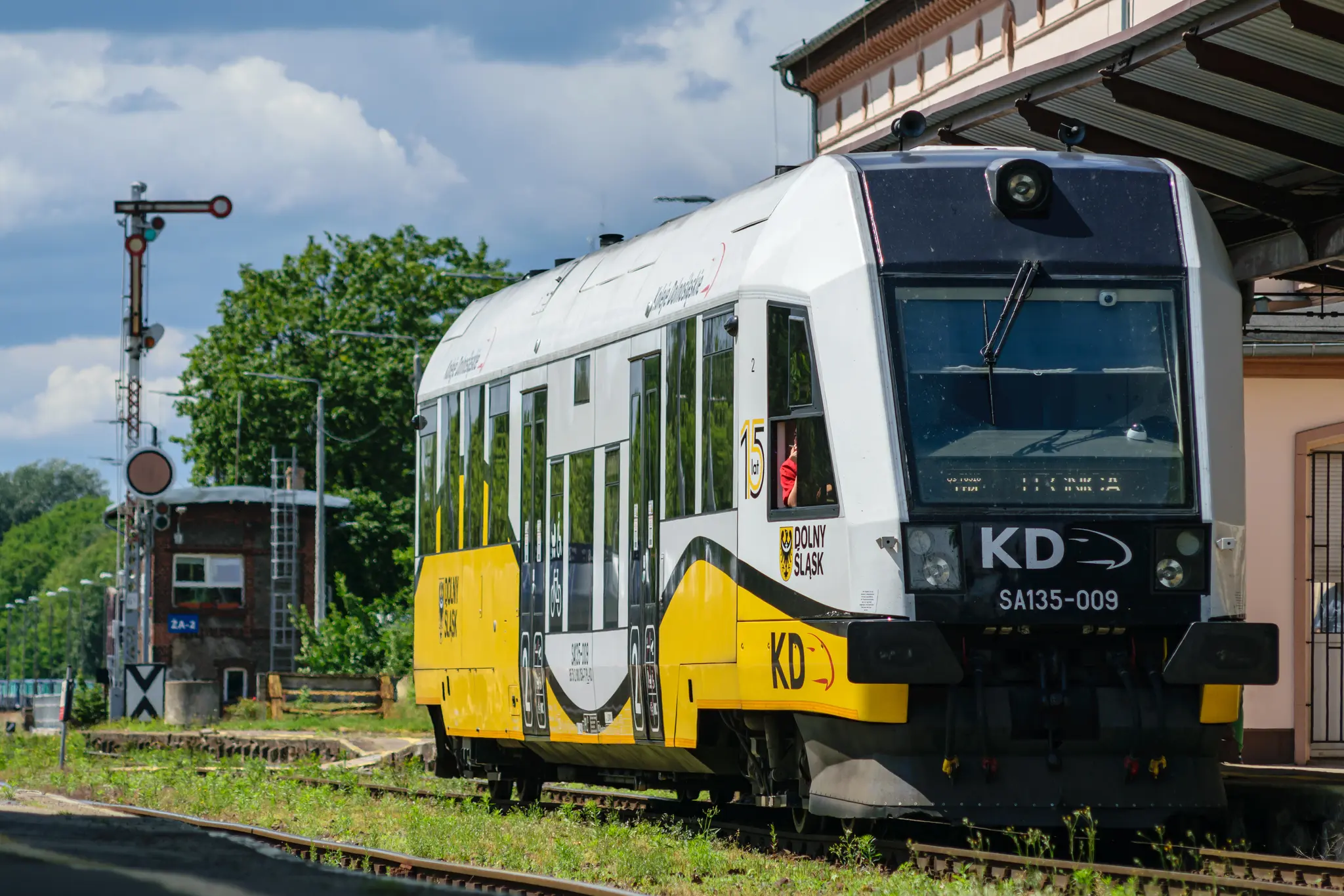 White-yellow train at a station