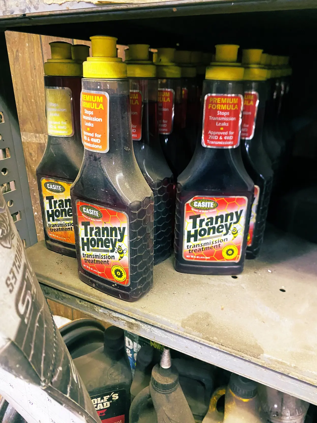 shelf filled with bottles of "Tranny Honey"