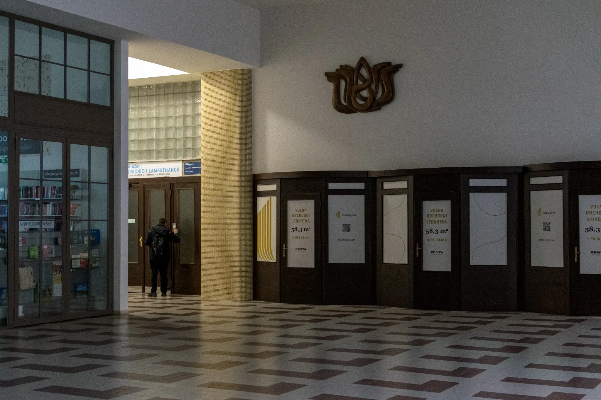 empty hall with someone entering some other place through here