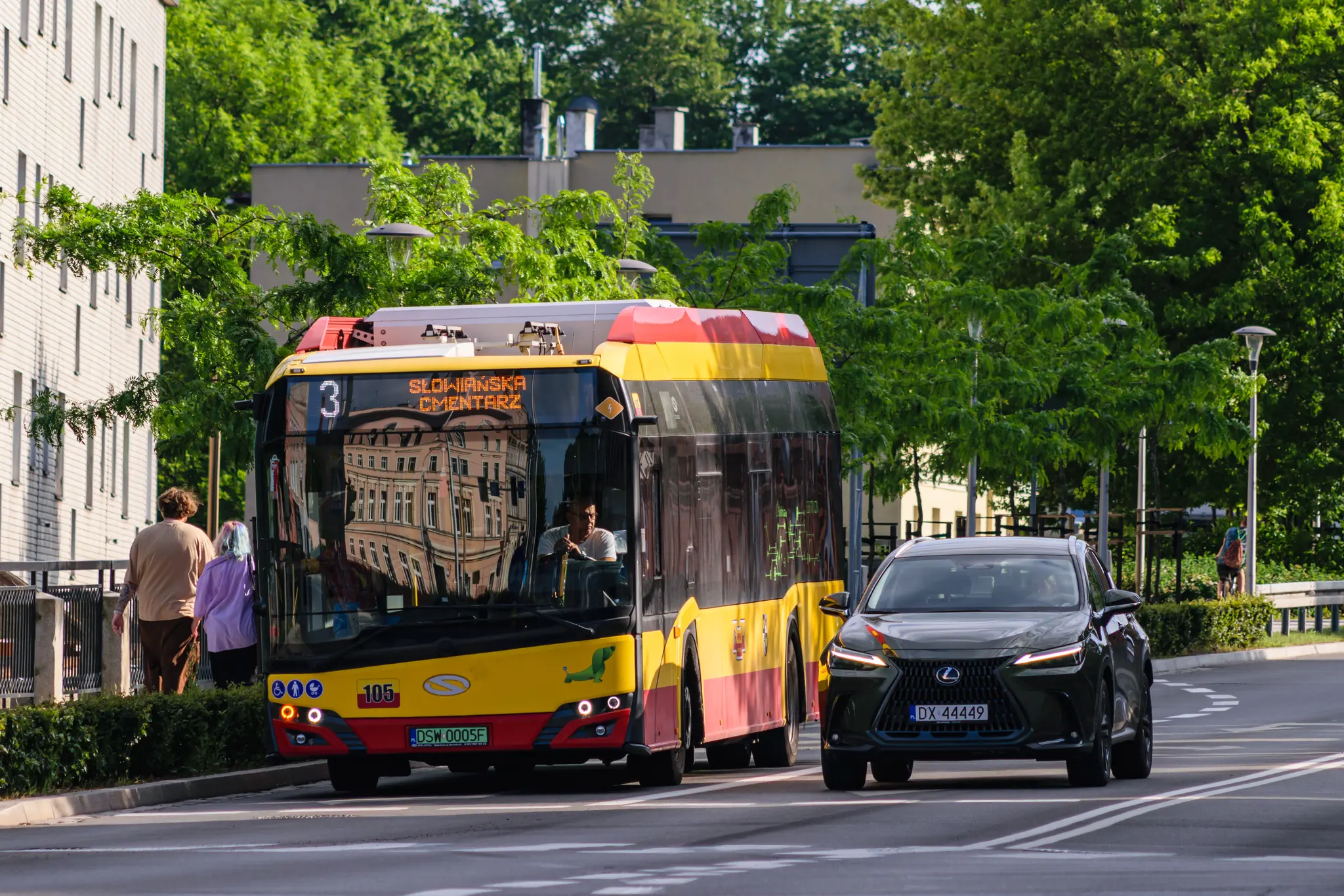 Yellow-red bus waiting at a red light