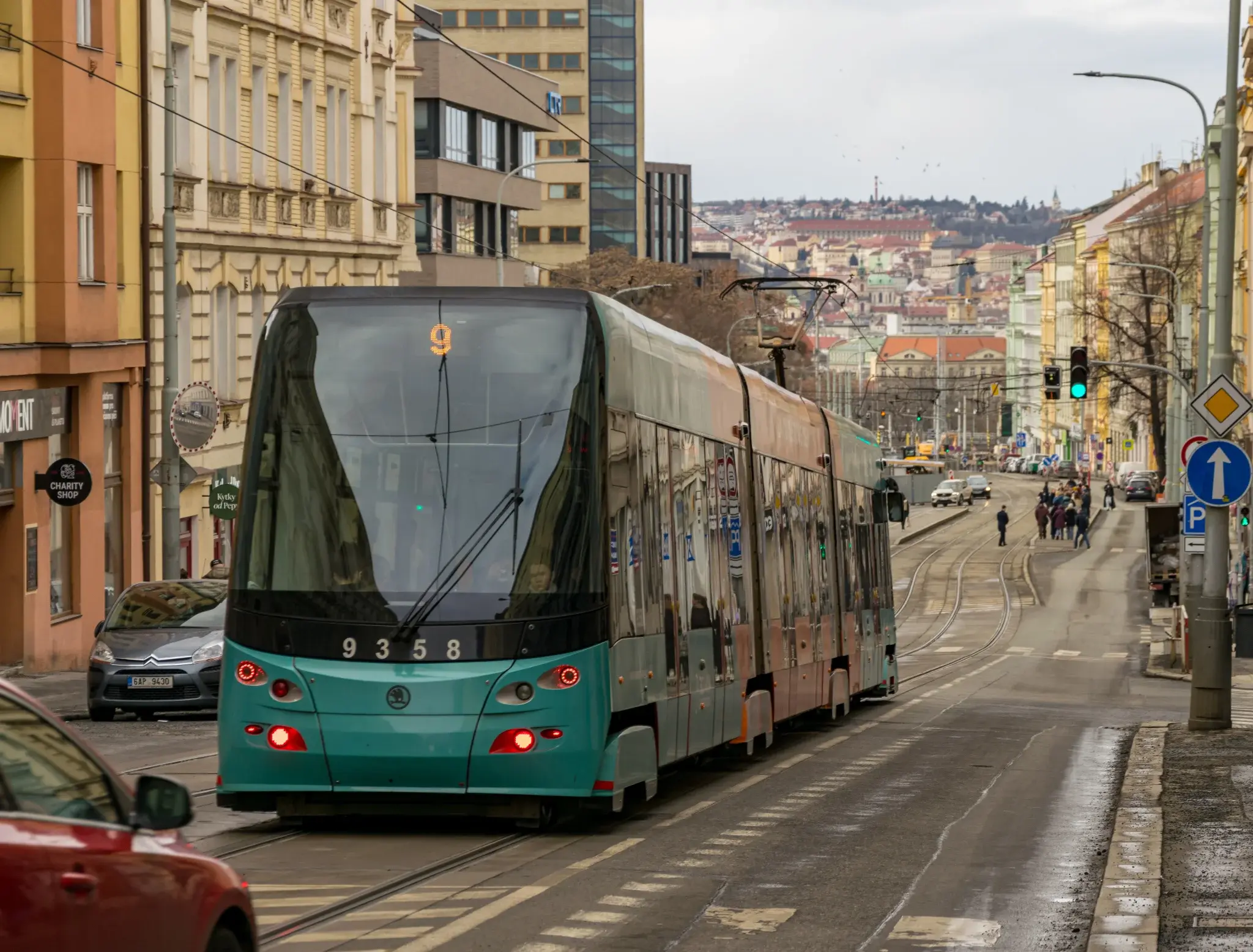 teal-ish? tram on a street